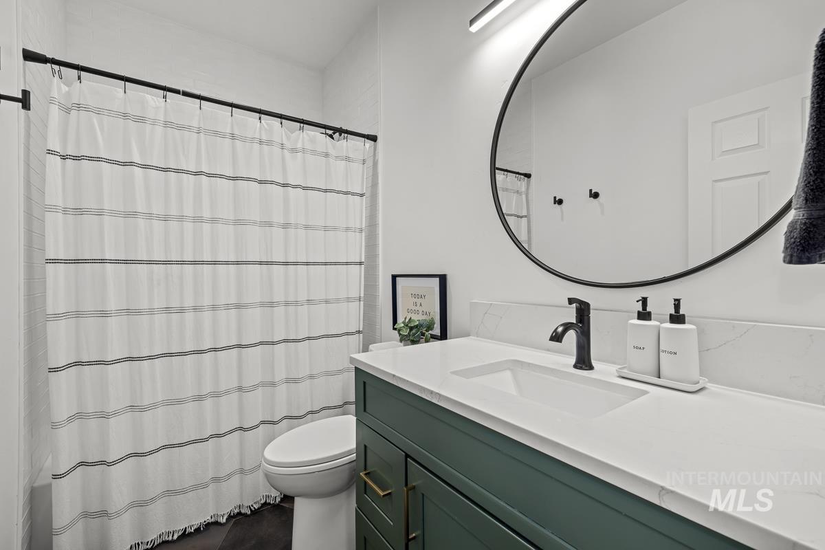 Bathroom featuring vanity and toilet