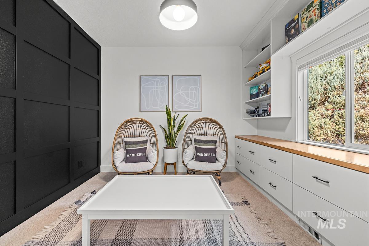 Office area featuring light colored carpet and baseboards