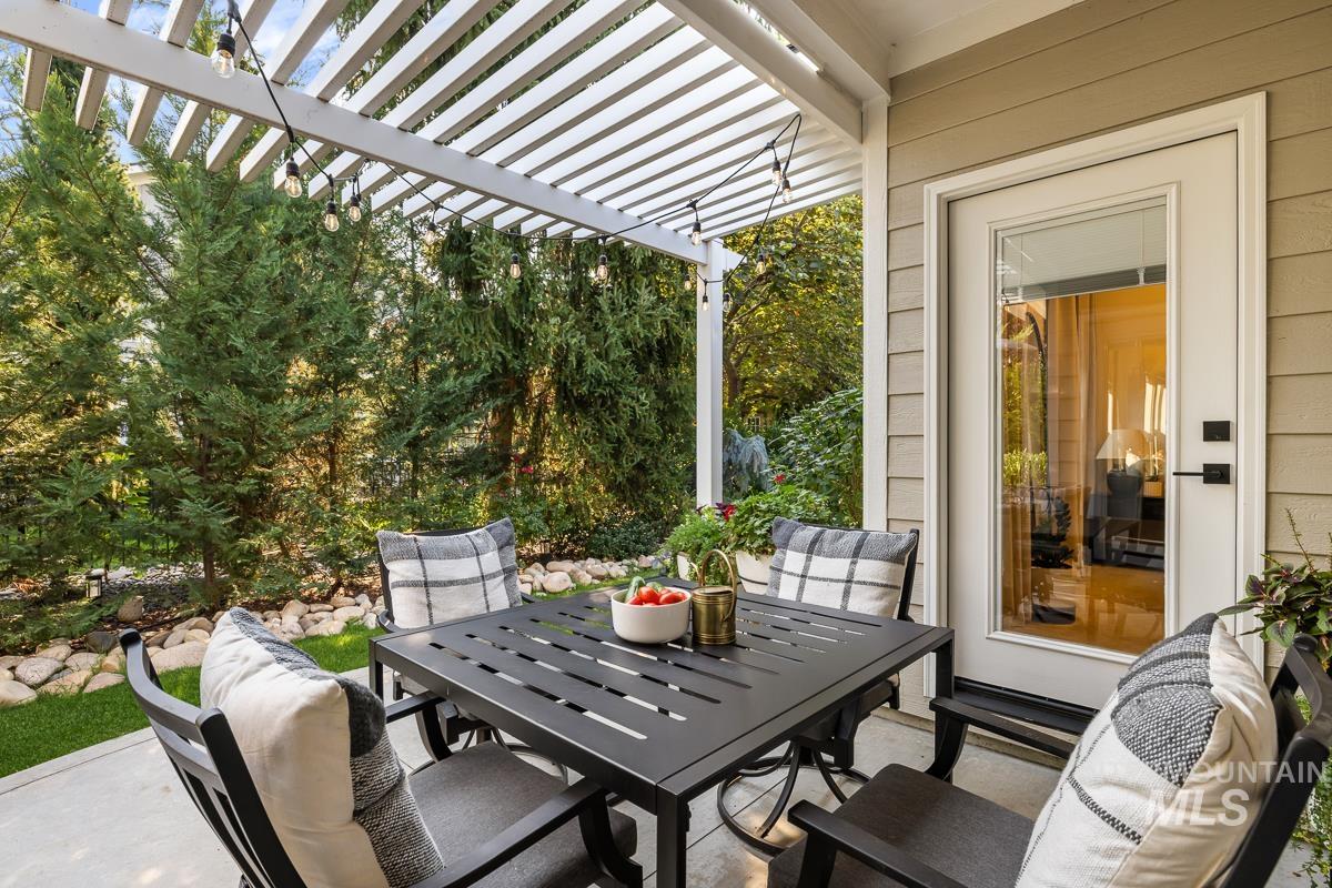 View of patio with a pergola and outdoor dining area
