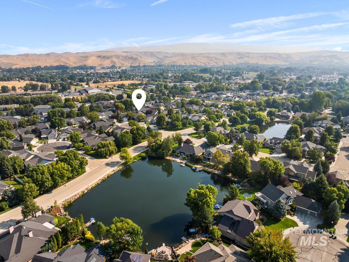 View of property location with nearby suburban area and a water and mountain view