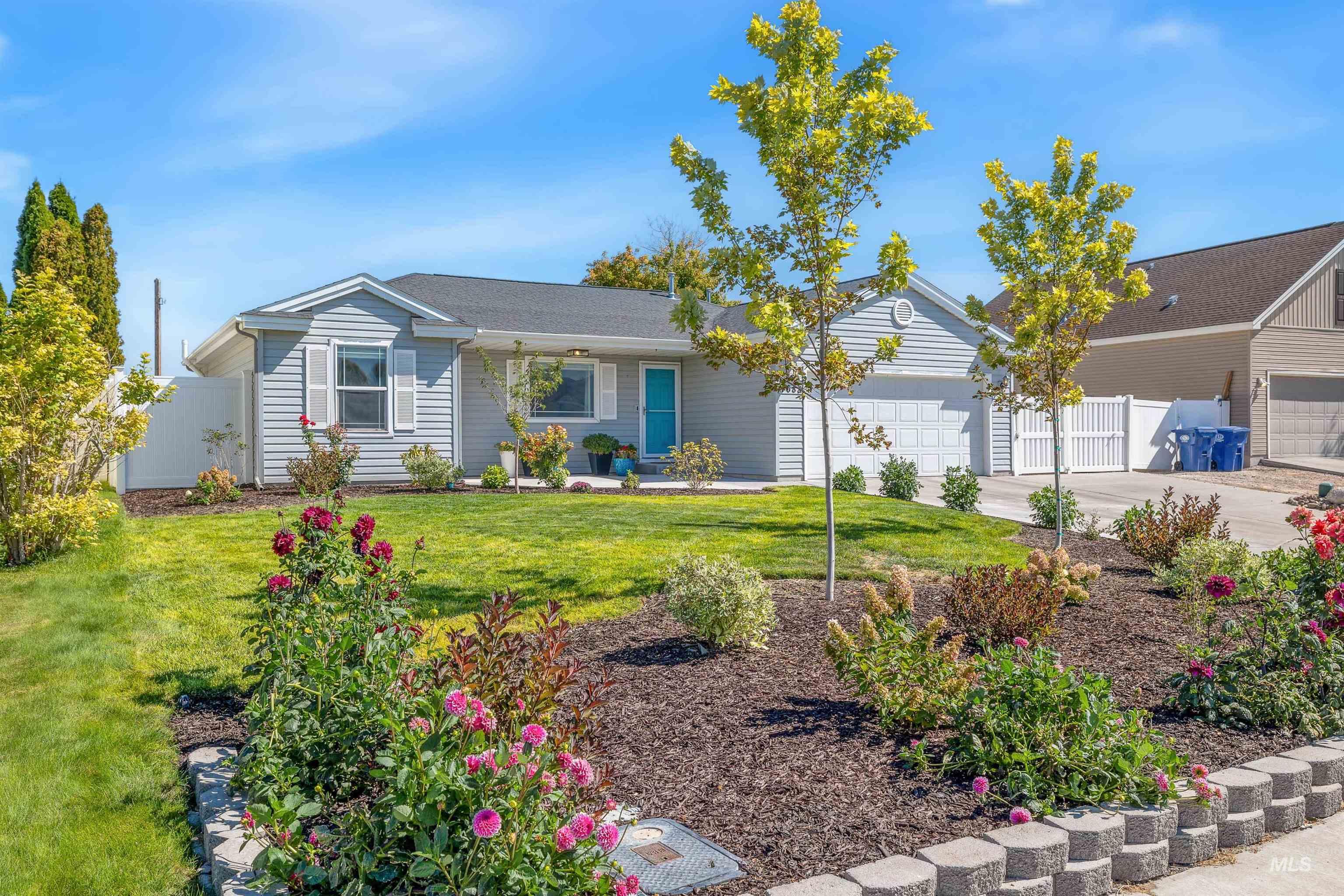 Ranch-style house featuring driveway, a garage, and covered porch