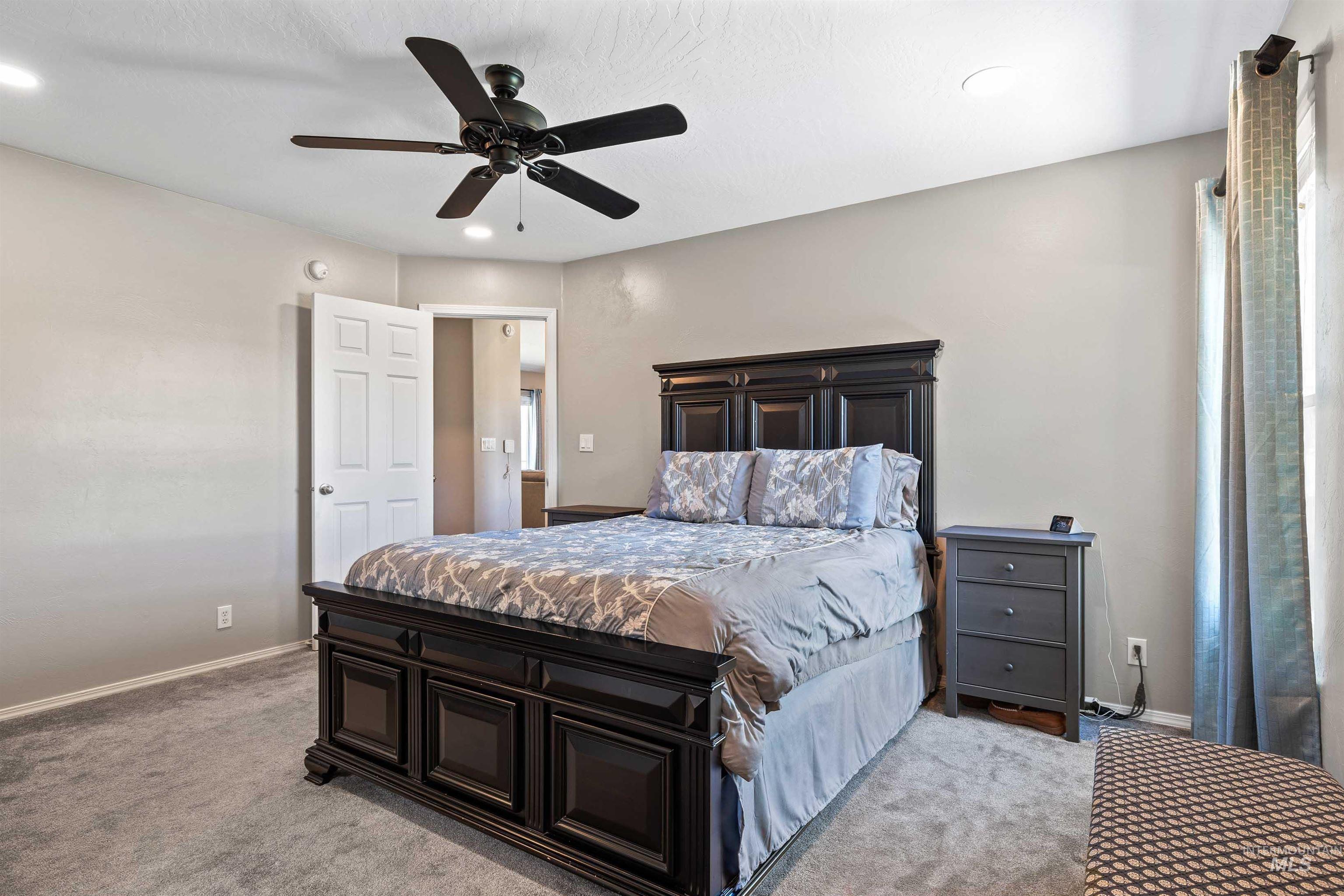Bedroom with a ceiling fan, light carpet, and recessed lighting