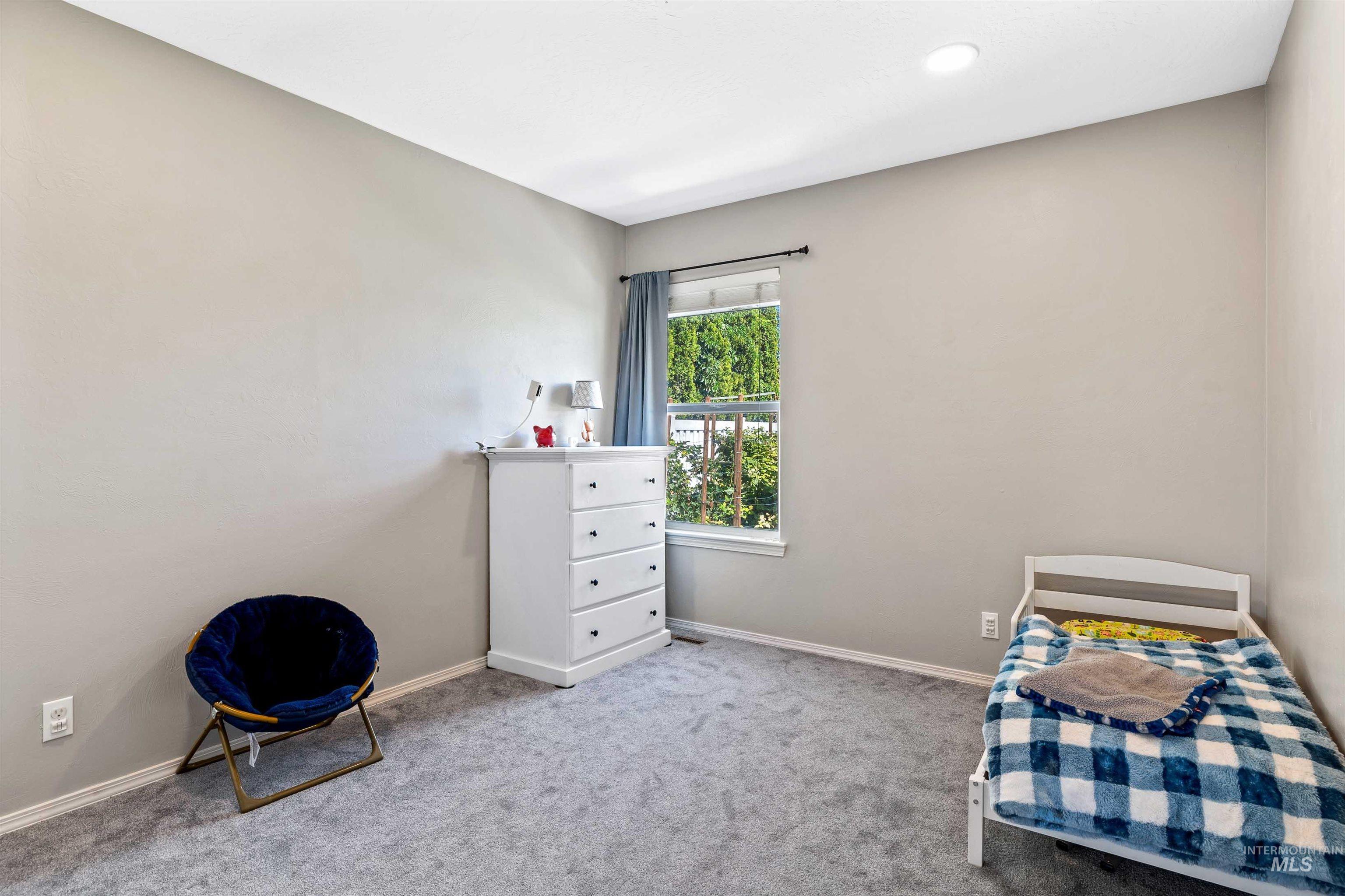 Bedroom featuring carpet floors and baseboards