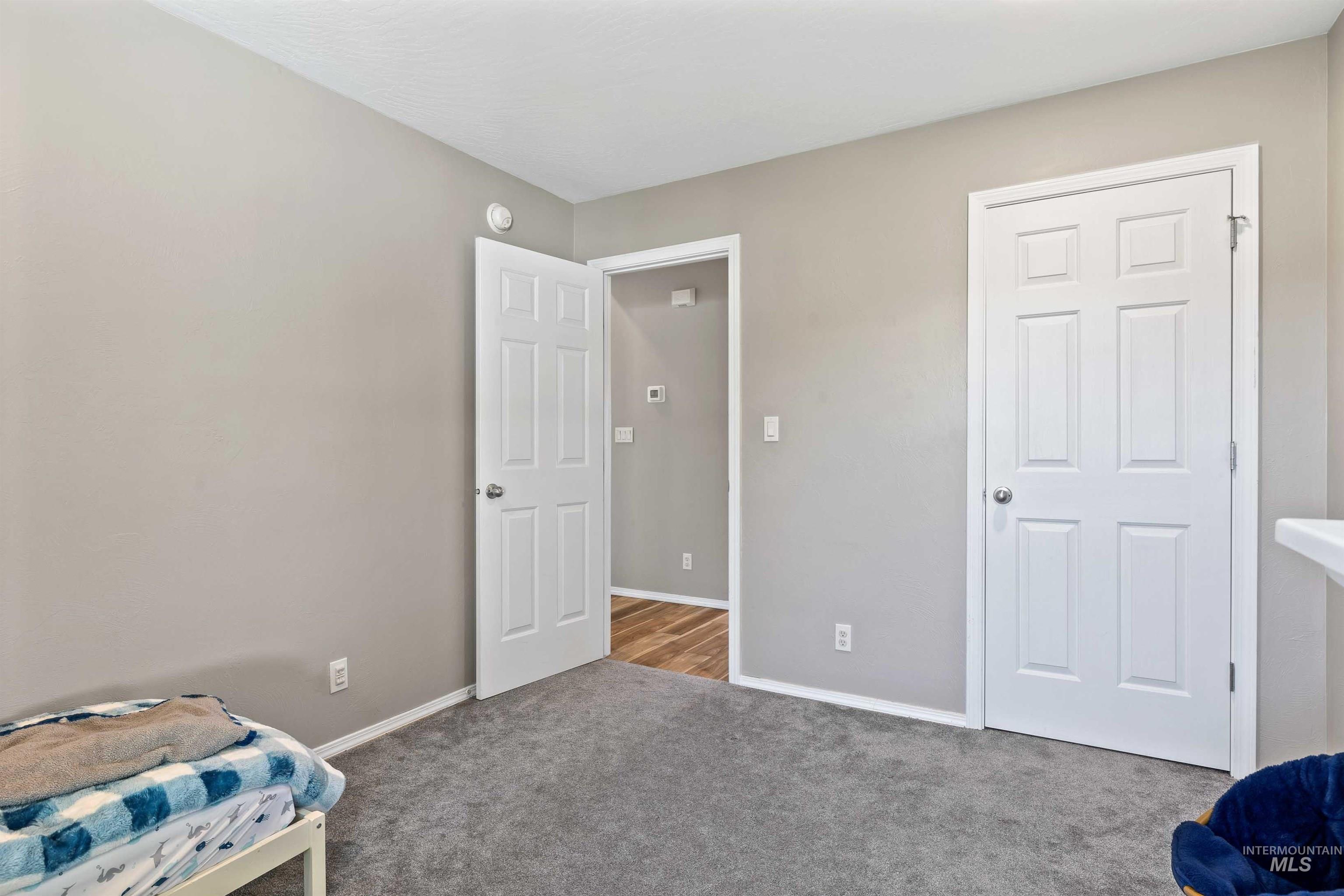 Carpeted bedroom with baseboards