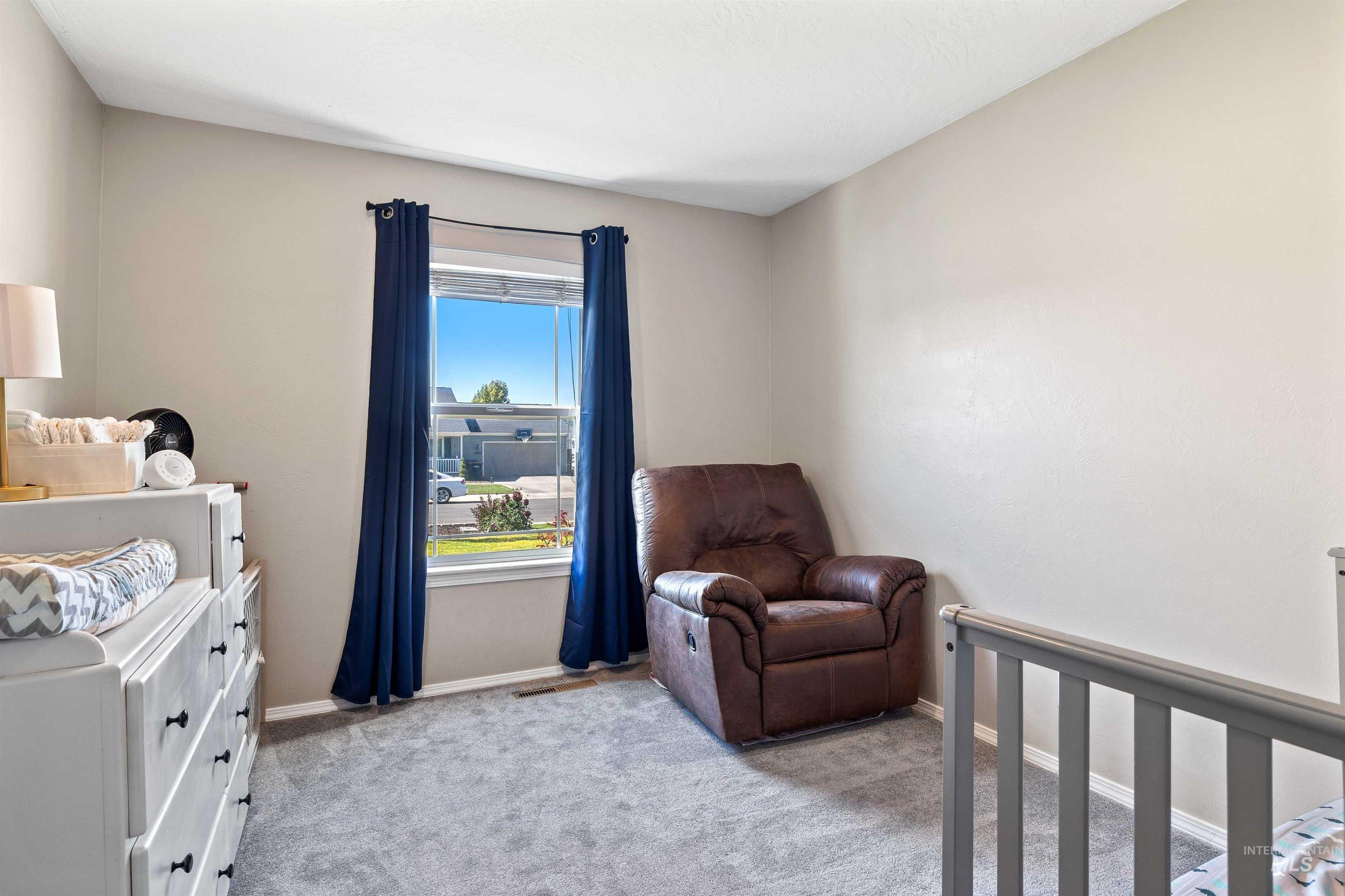 Bedroom with carpet and a nursery area