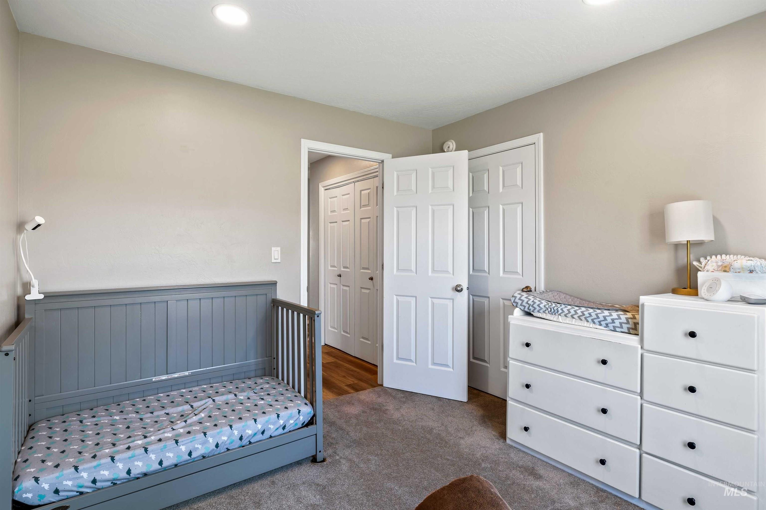 Bedroom featuring carpet, recessed lighting, and a closet