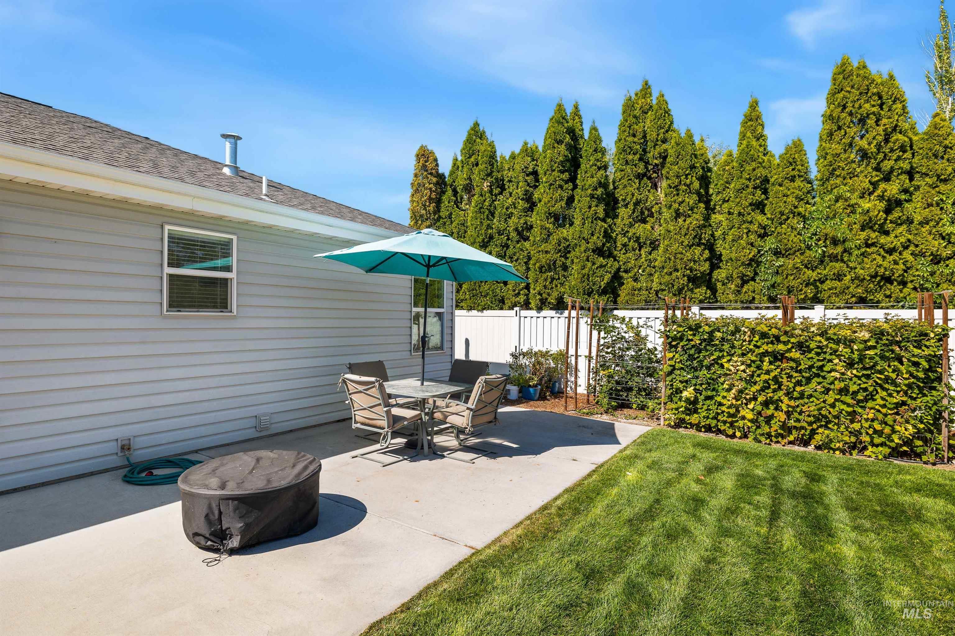 Fenced backyard with a patio