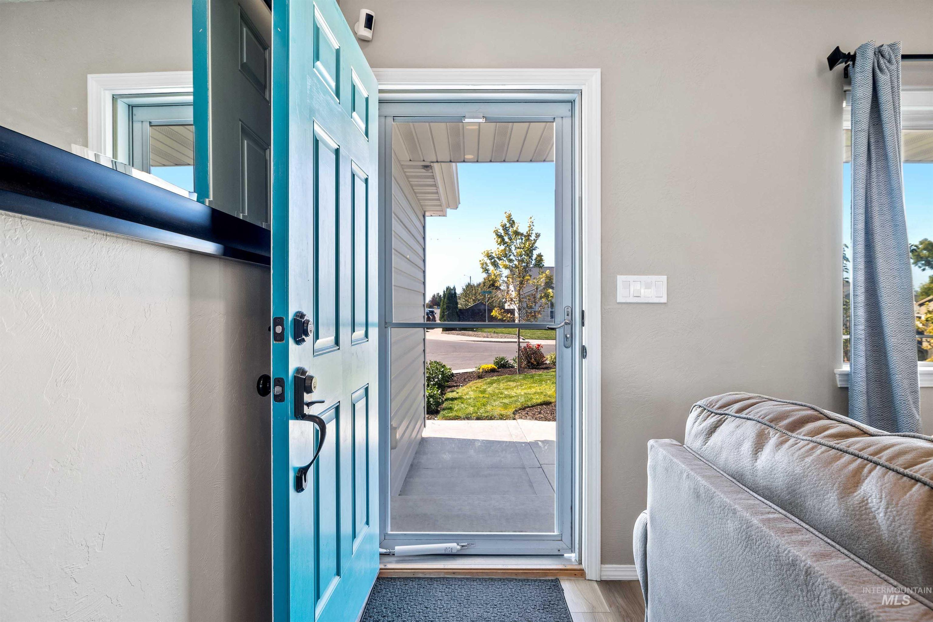Doorway to outside with wood finished floors and baseboards