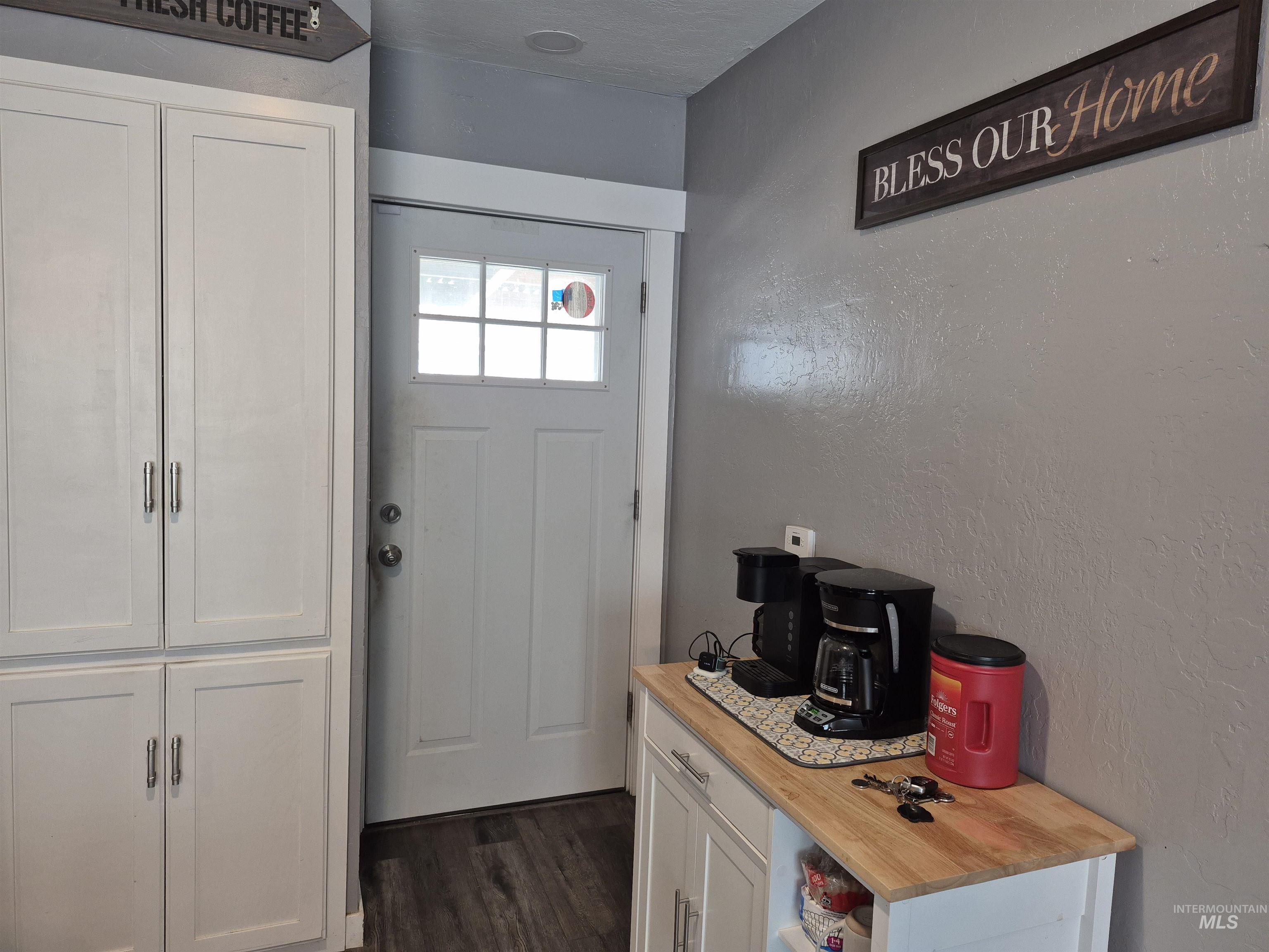 Entryway with a textured wall and wood finished floors