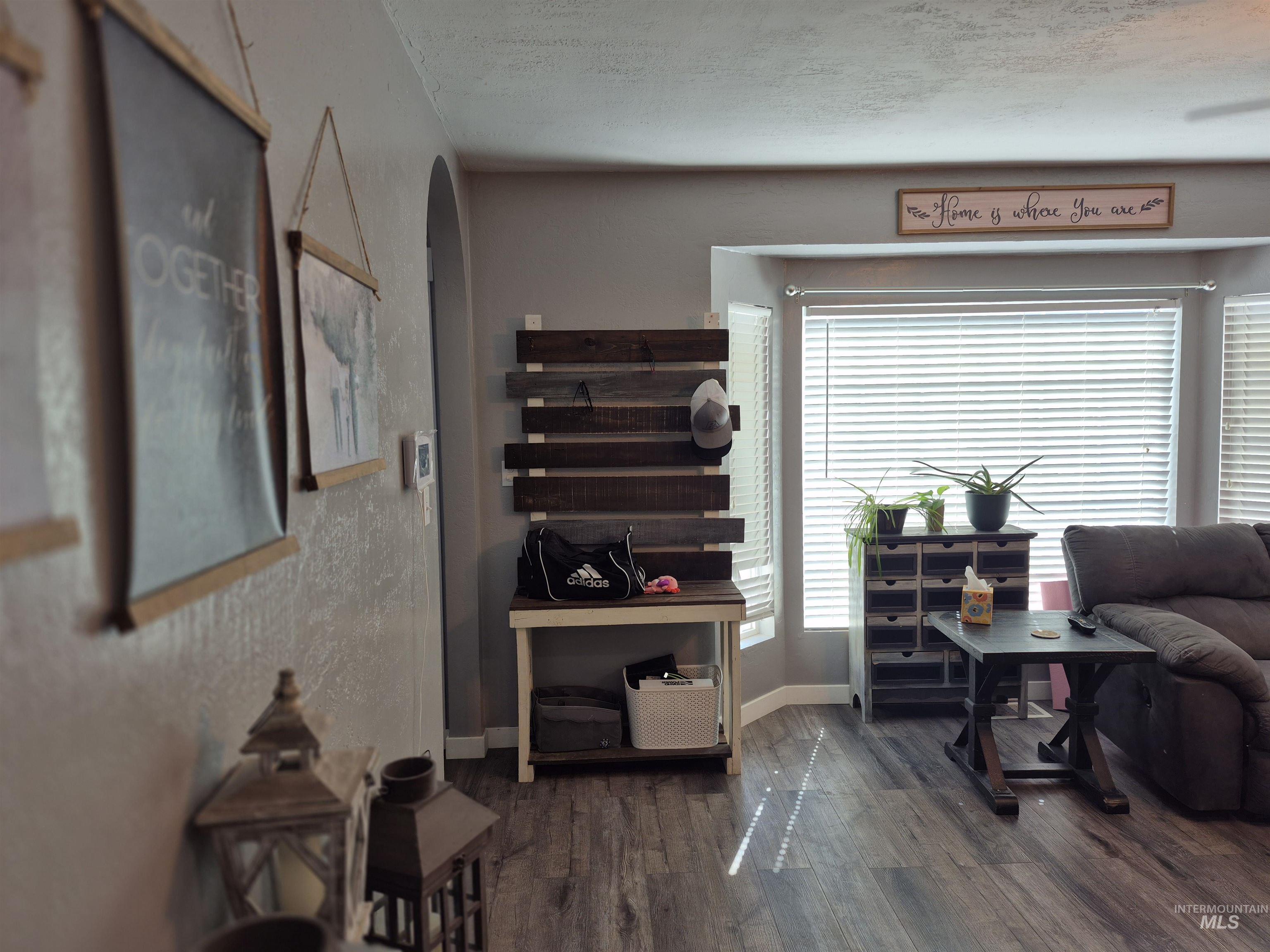 Sitting room featuring dark wood-style floors and a textured ceiling