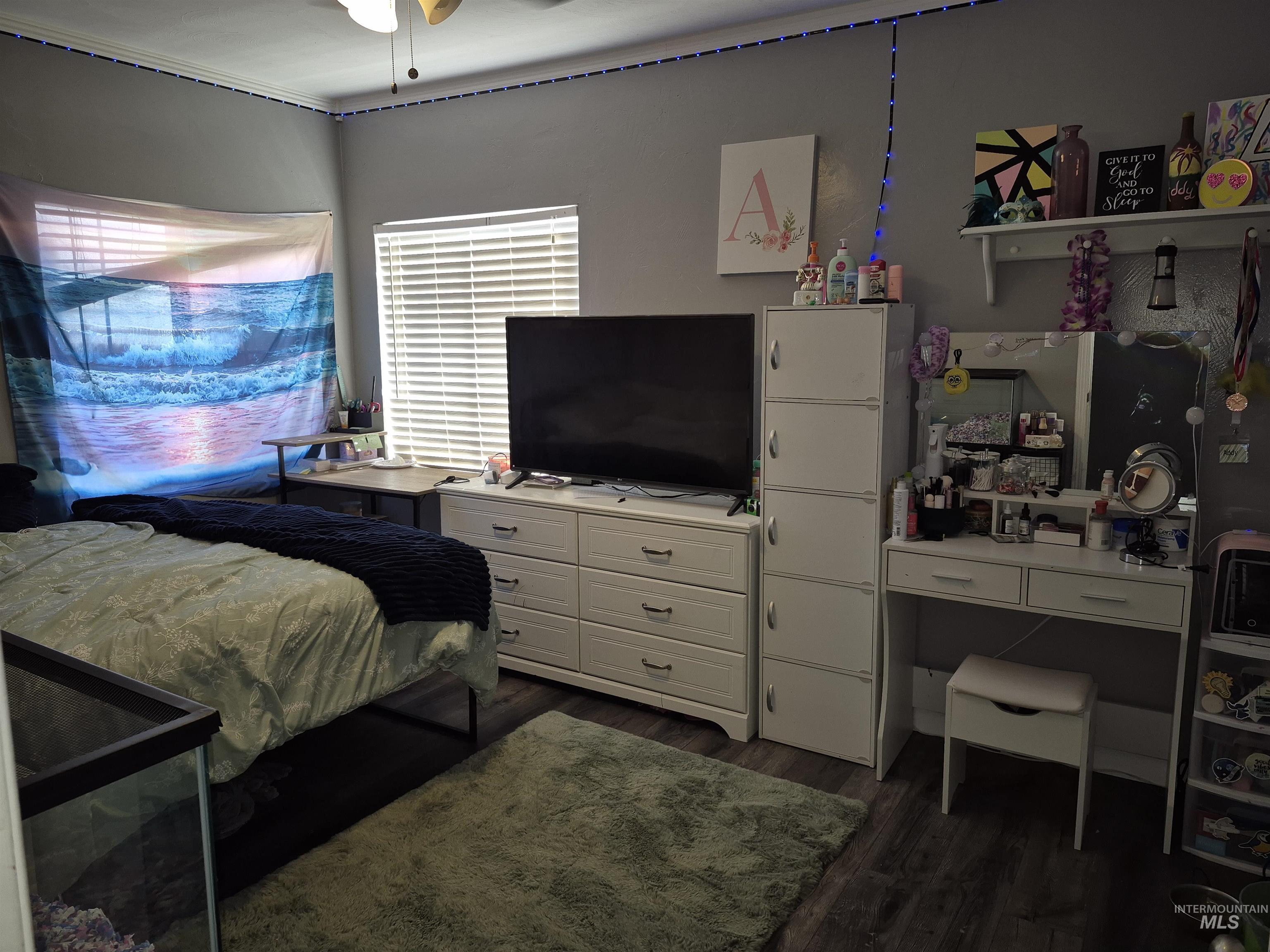 Bedroom with dark wood-style flooring