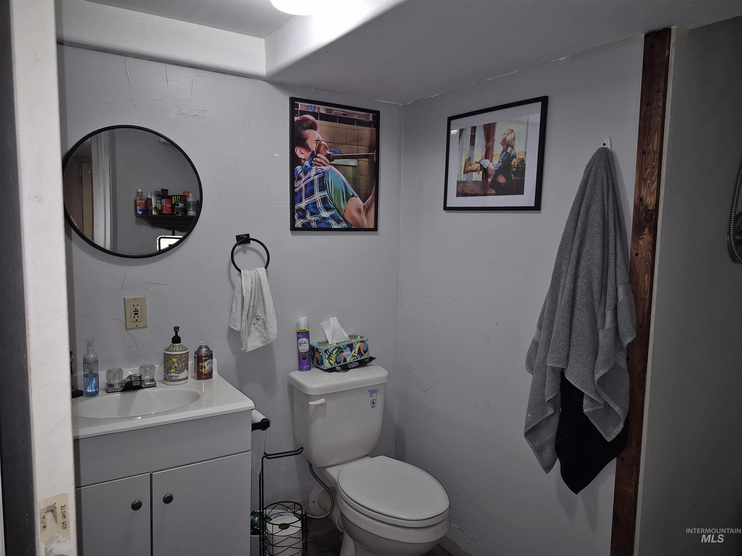 Half bathroom featuring vanity and toilet