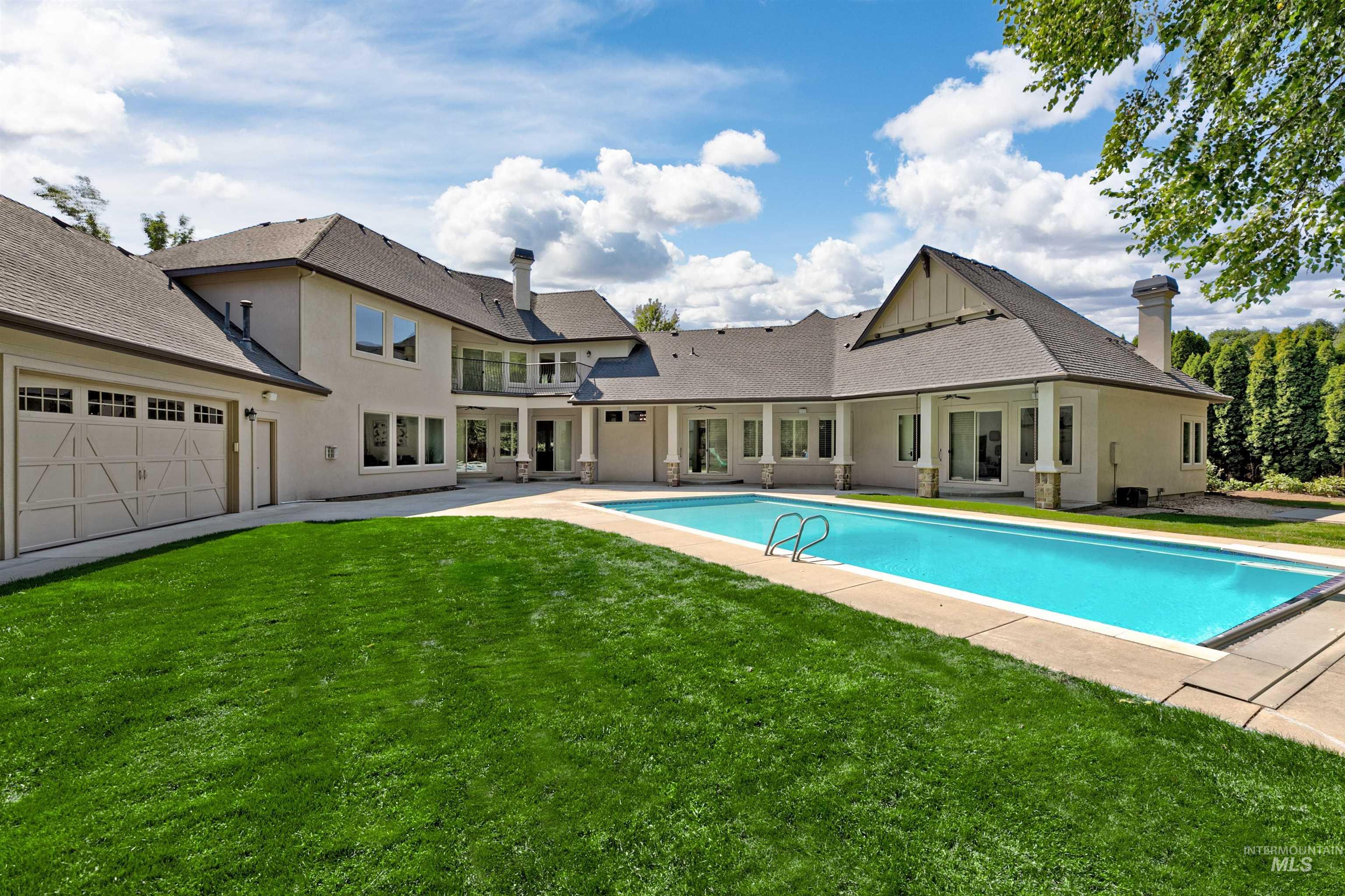 Swimming pool with a patio area, a yard, and a balcony