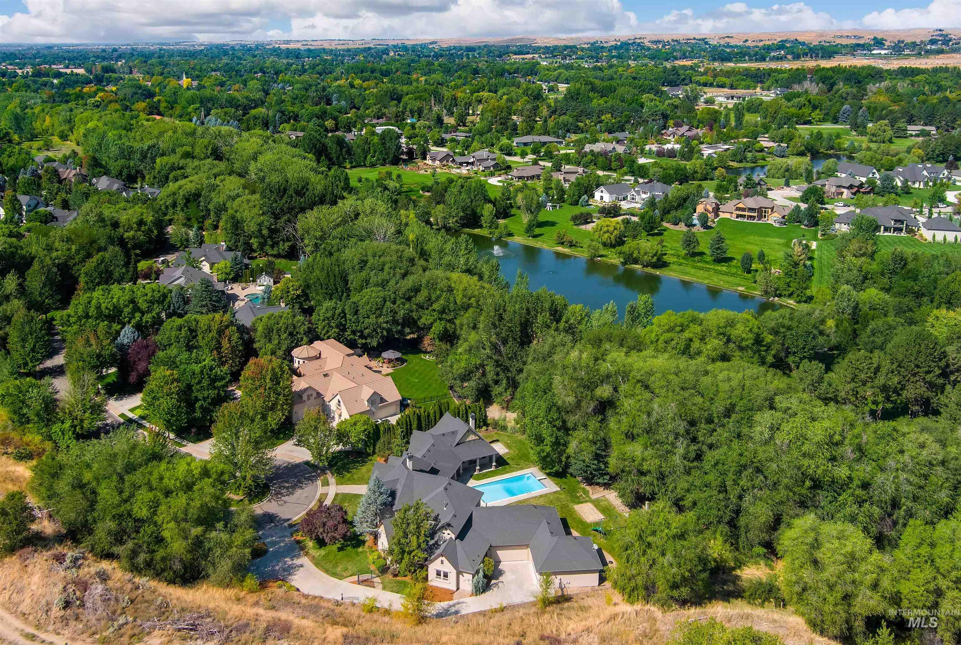 Aerial perspective of suburban area featuring a large body of water