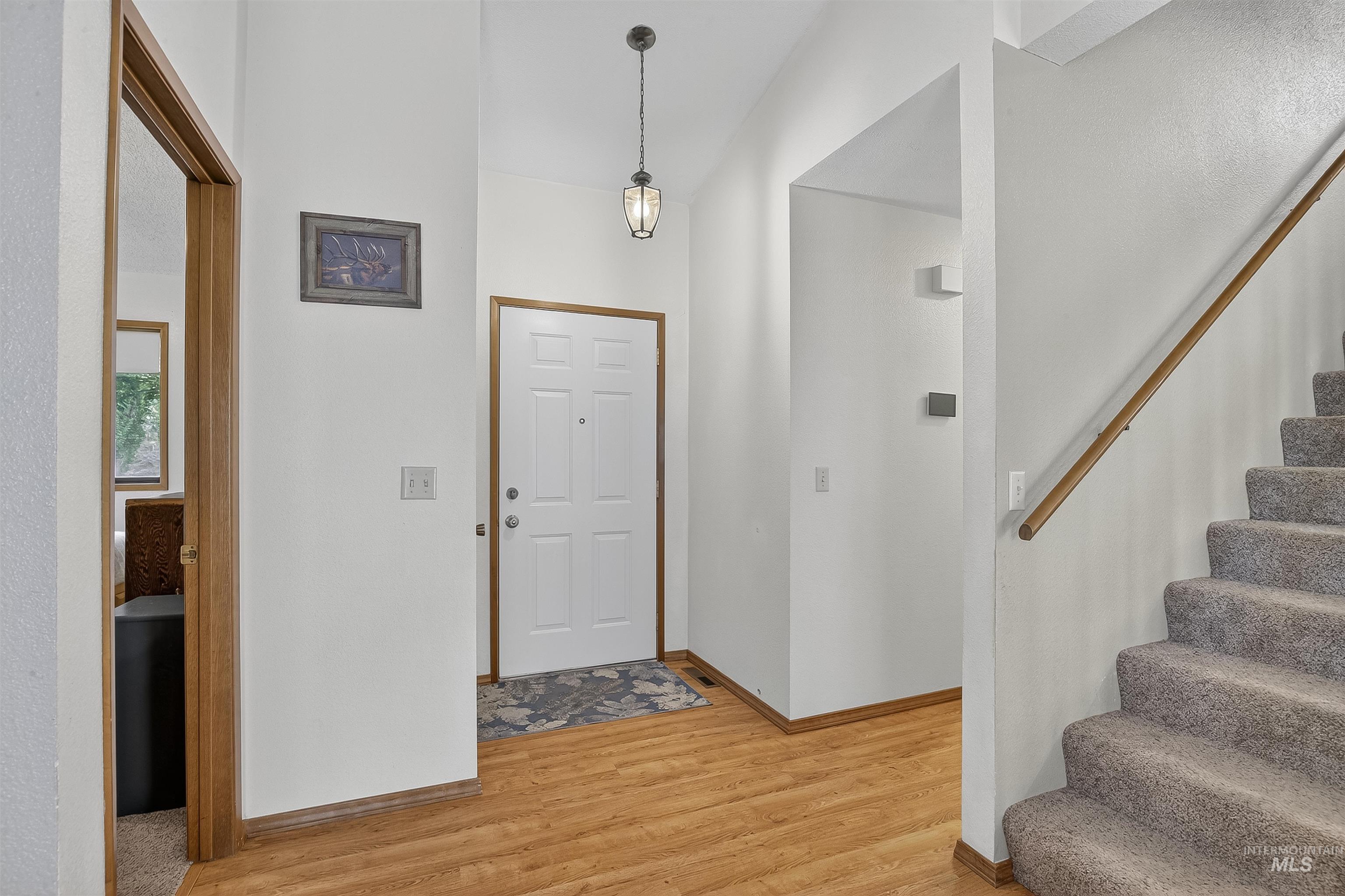 Entryway featuring light wood-style flooring and stairs
