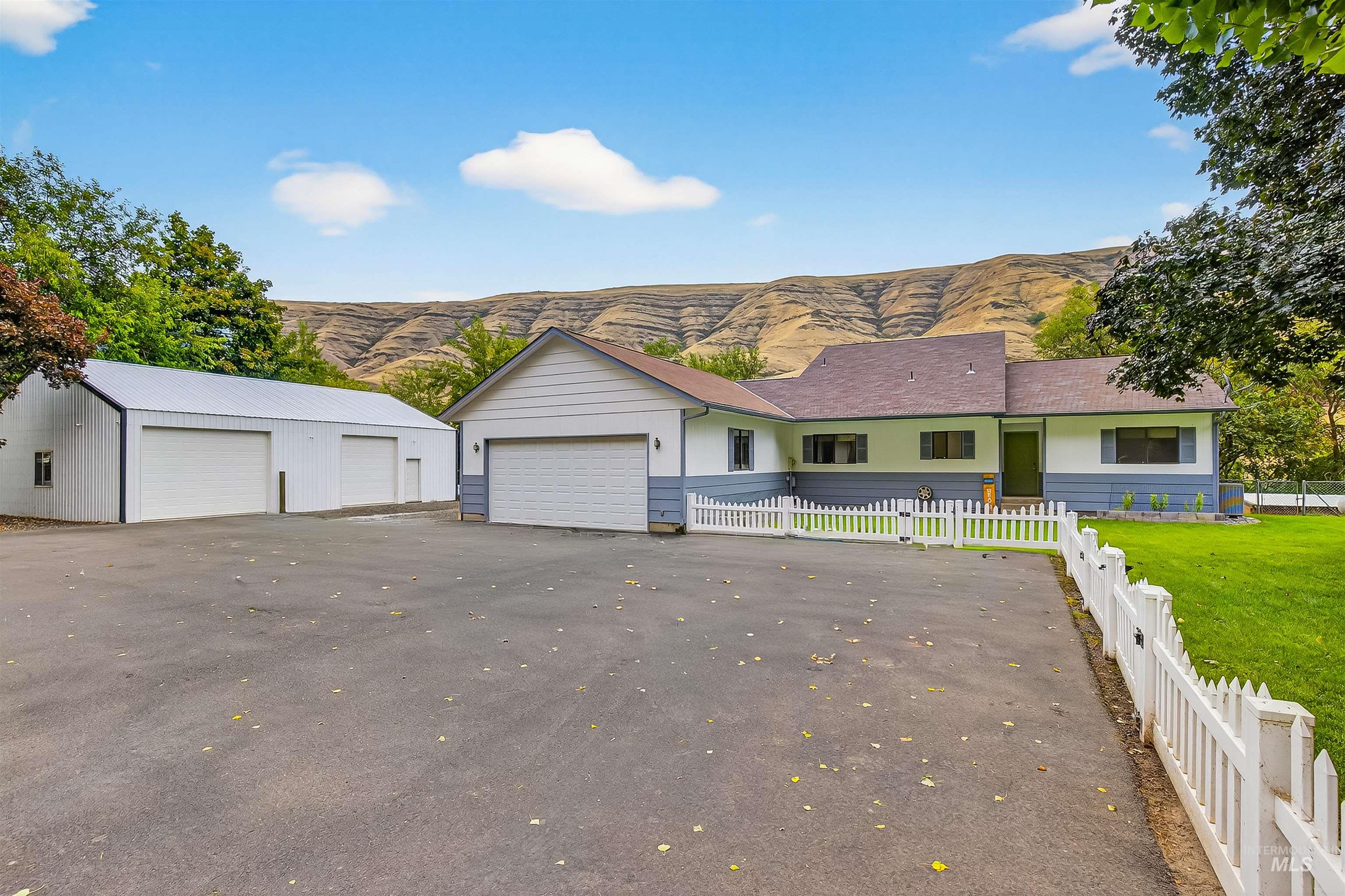 Ranch-style home with a mountain view and a detached garage