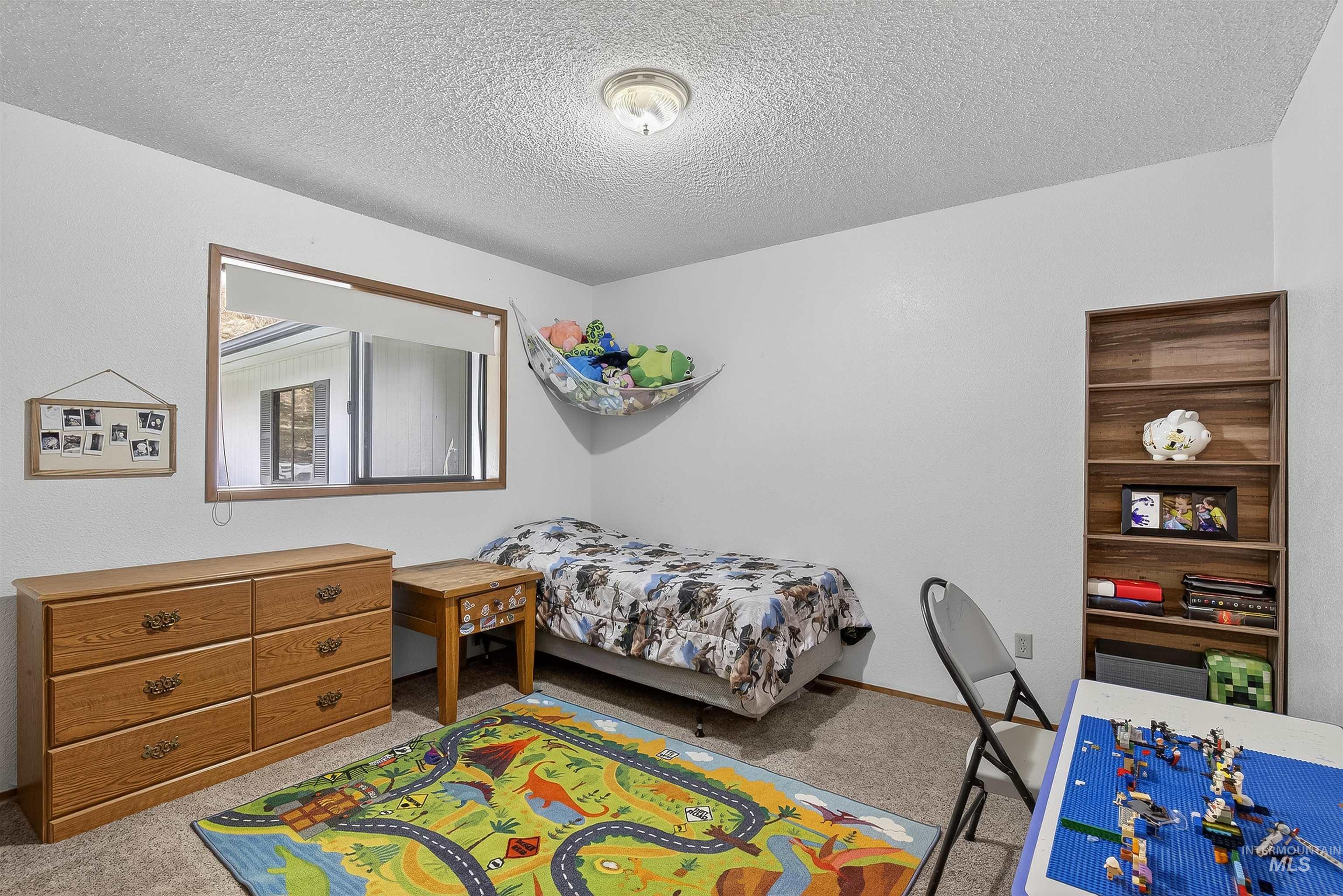 Bedroom with carpet floors and a textured ceiling