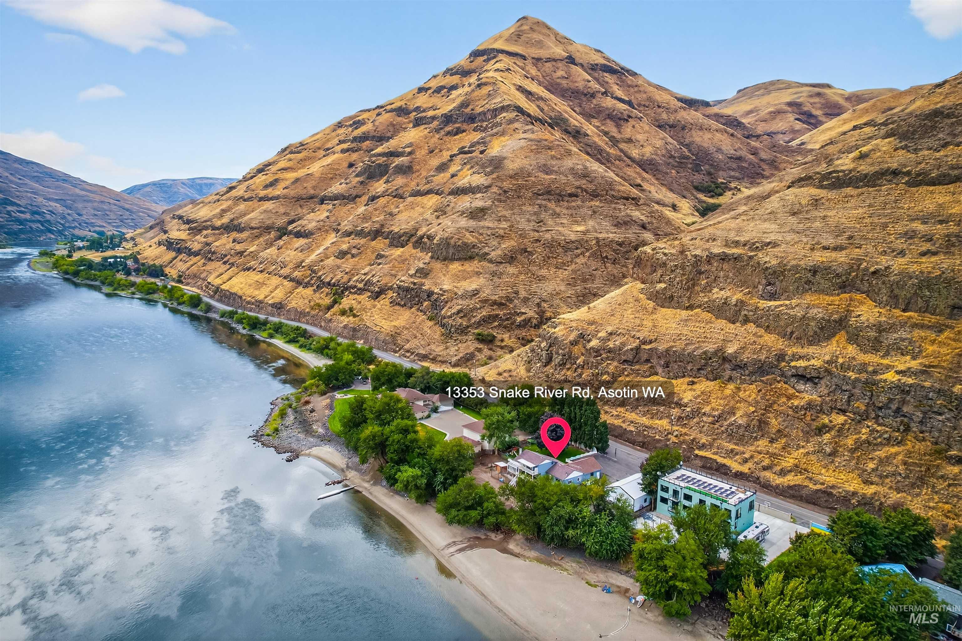 Aerial view of property's location with a water and mountain view
