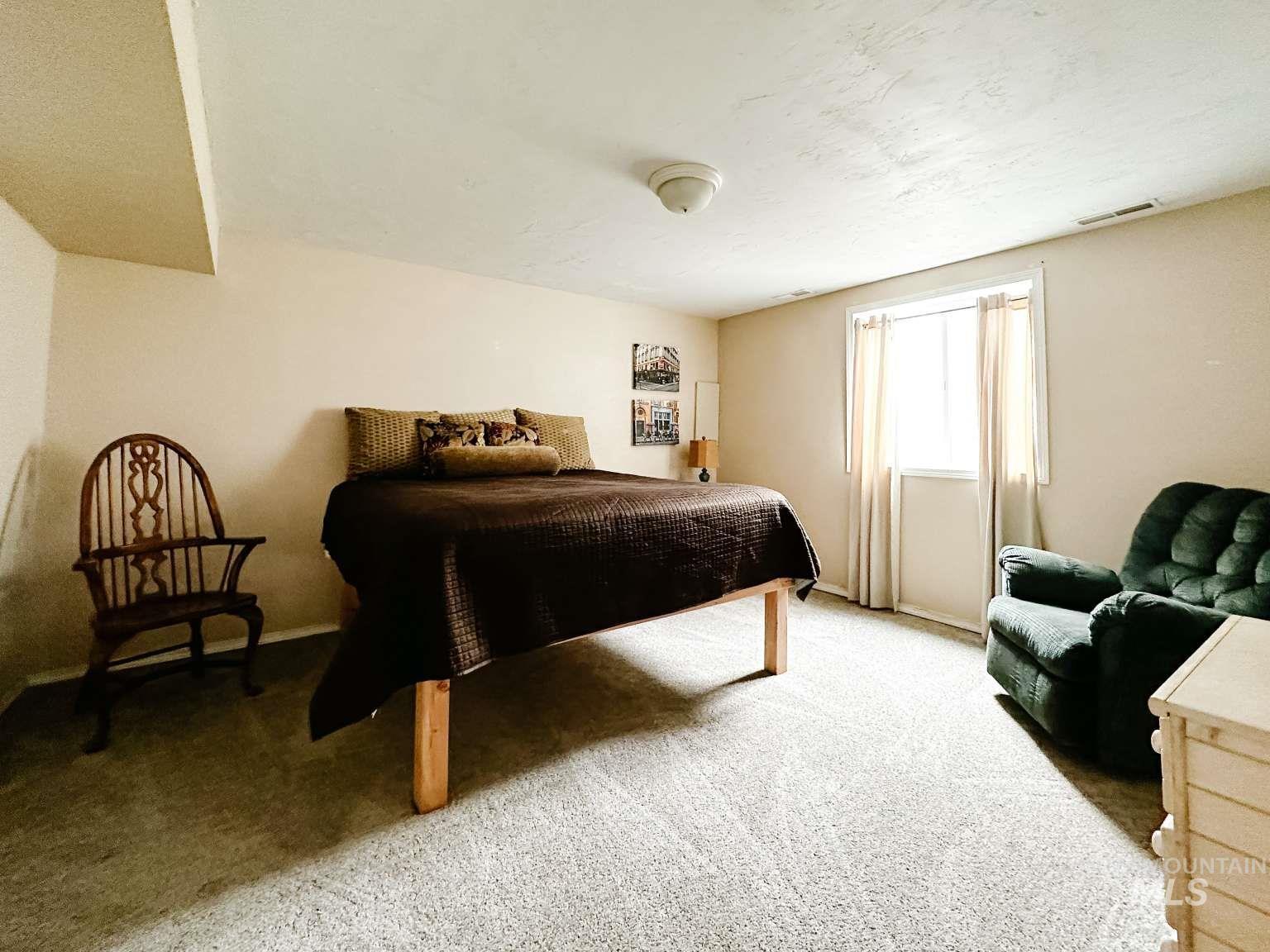 Bedroom featuring carpet floors and baseboards
