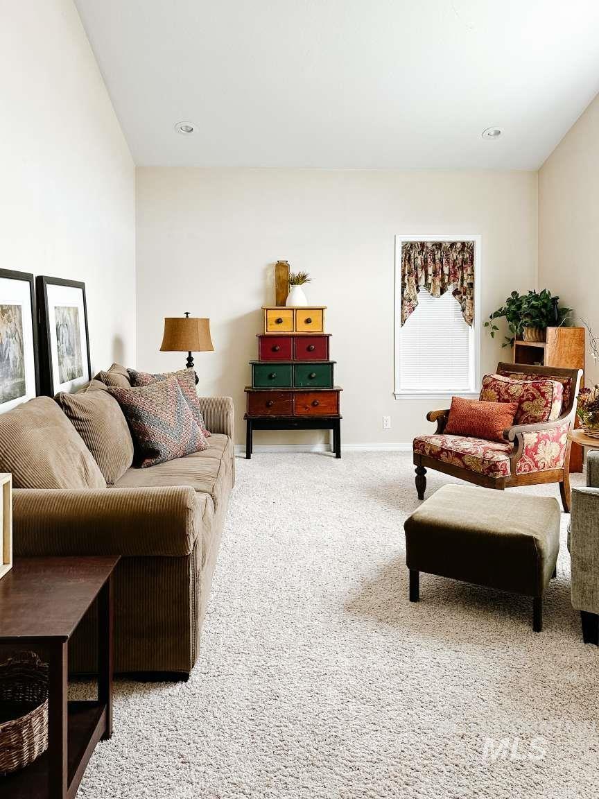 Living area featuring light carpet and recessed lighting