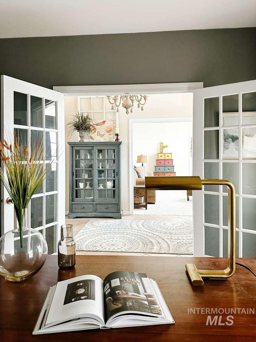 Detailed view of a chandelier and wood finished floors