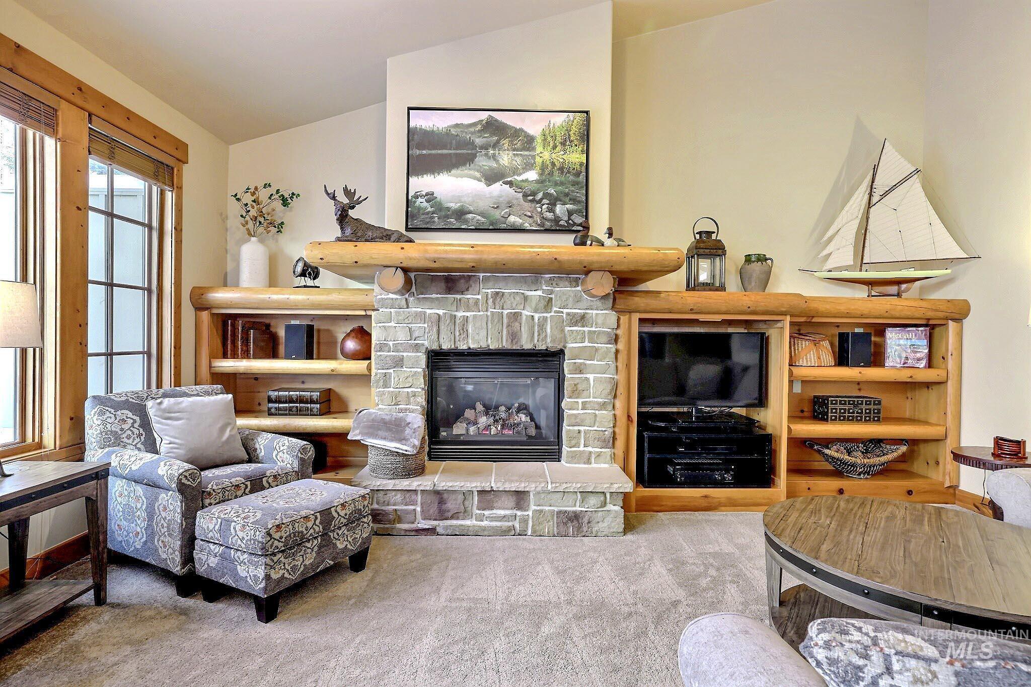 Living area featuring carpet floors and a fireplace