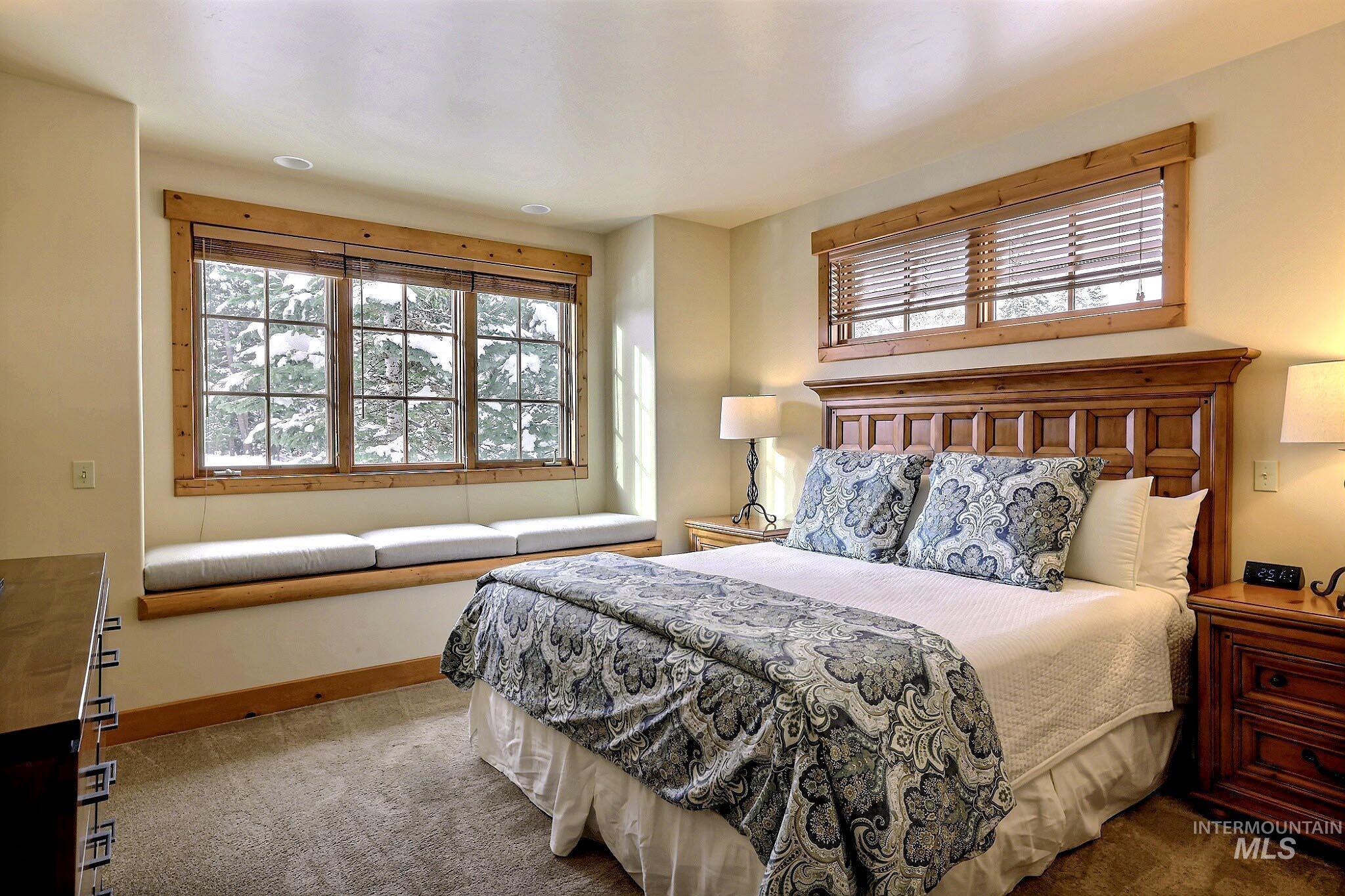 Bedroom featuring carpet and multiple windows