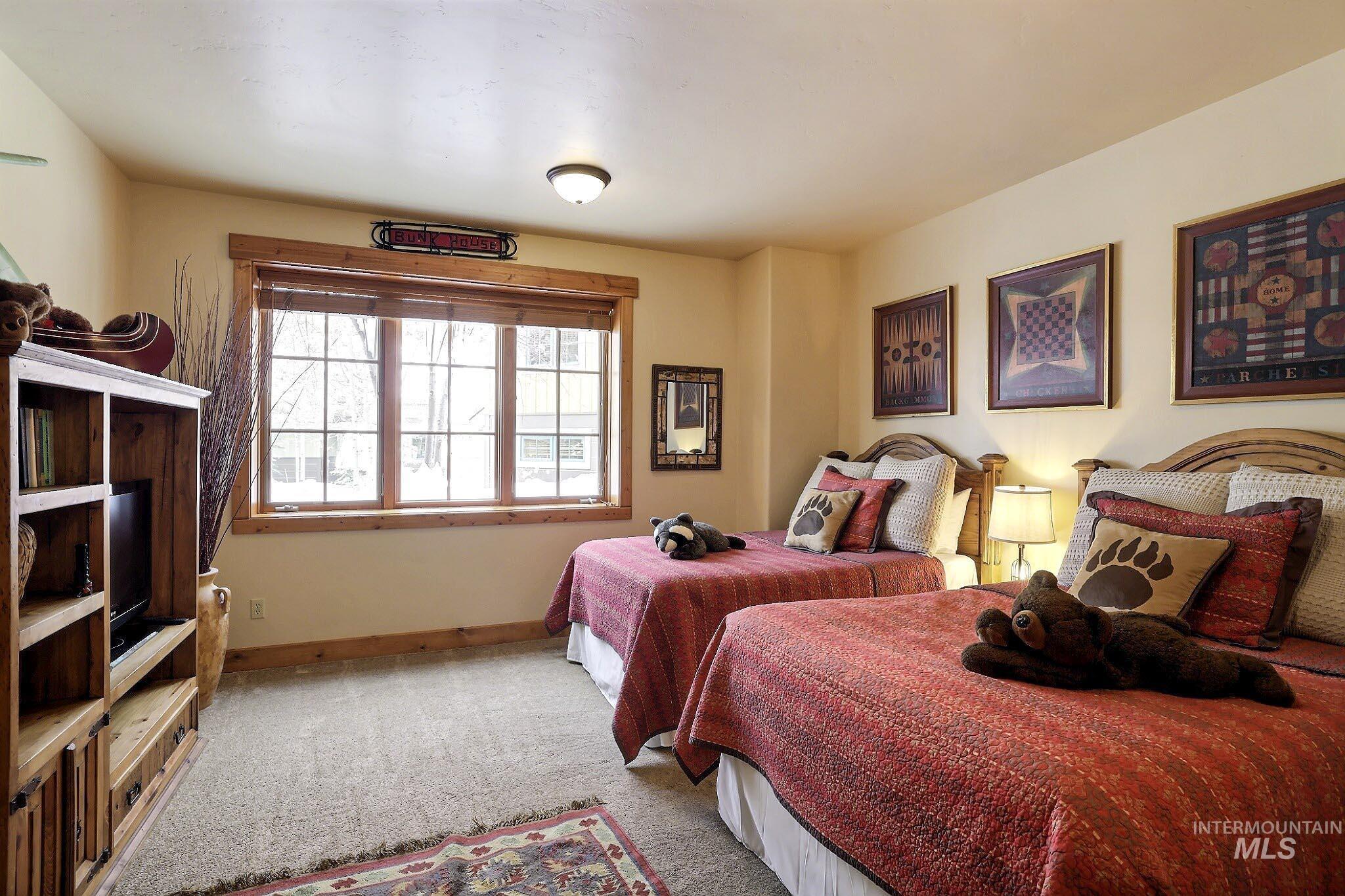 Bedroom featuring light colored carpet and baseboards