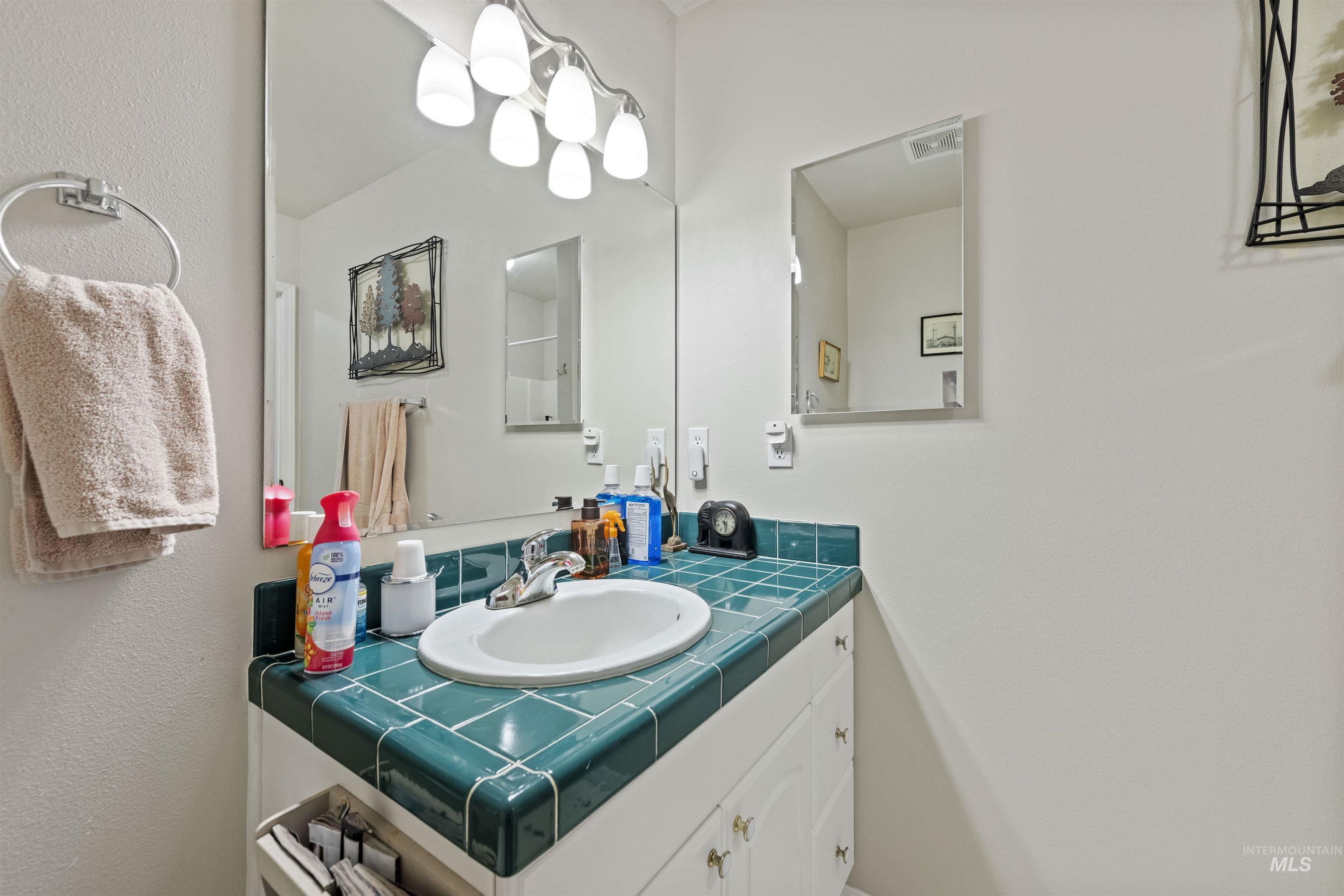 Bathroom featuring vanity and a textured wall