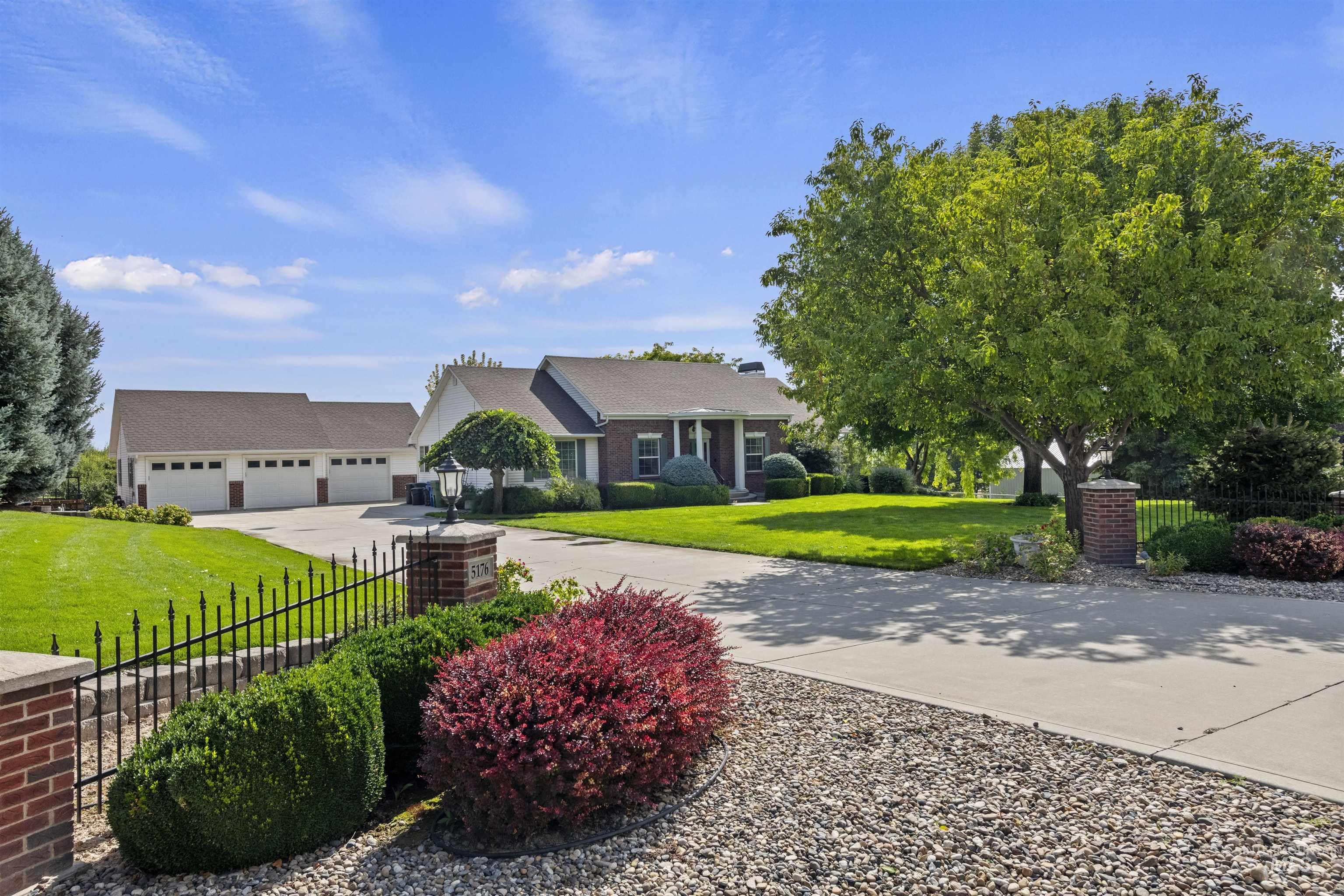 View of front of house featuring concrete driveway and a garage