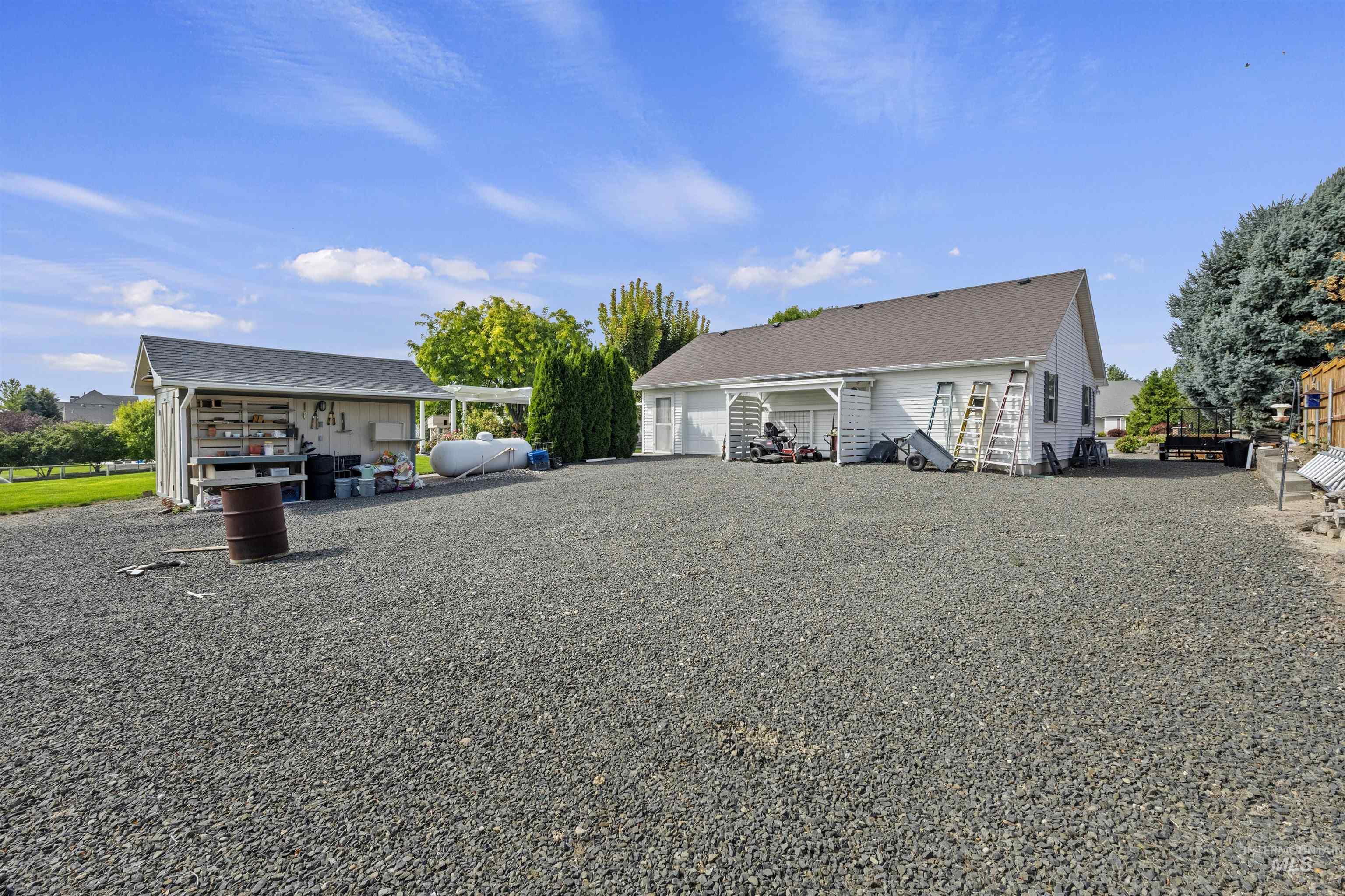 Rear view of house featuring driveway