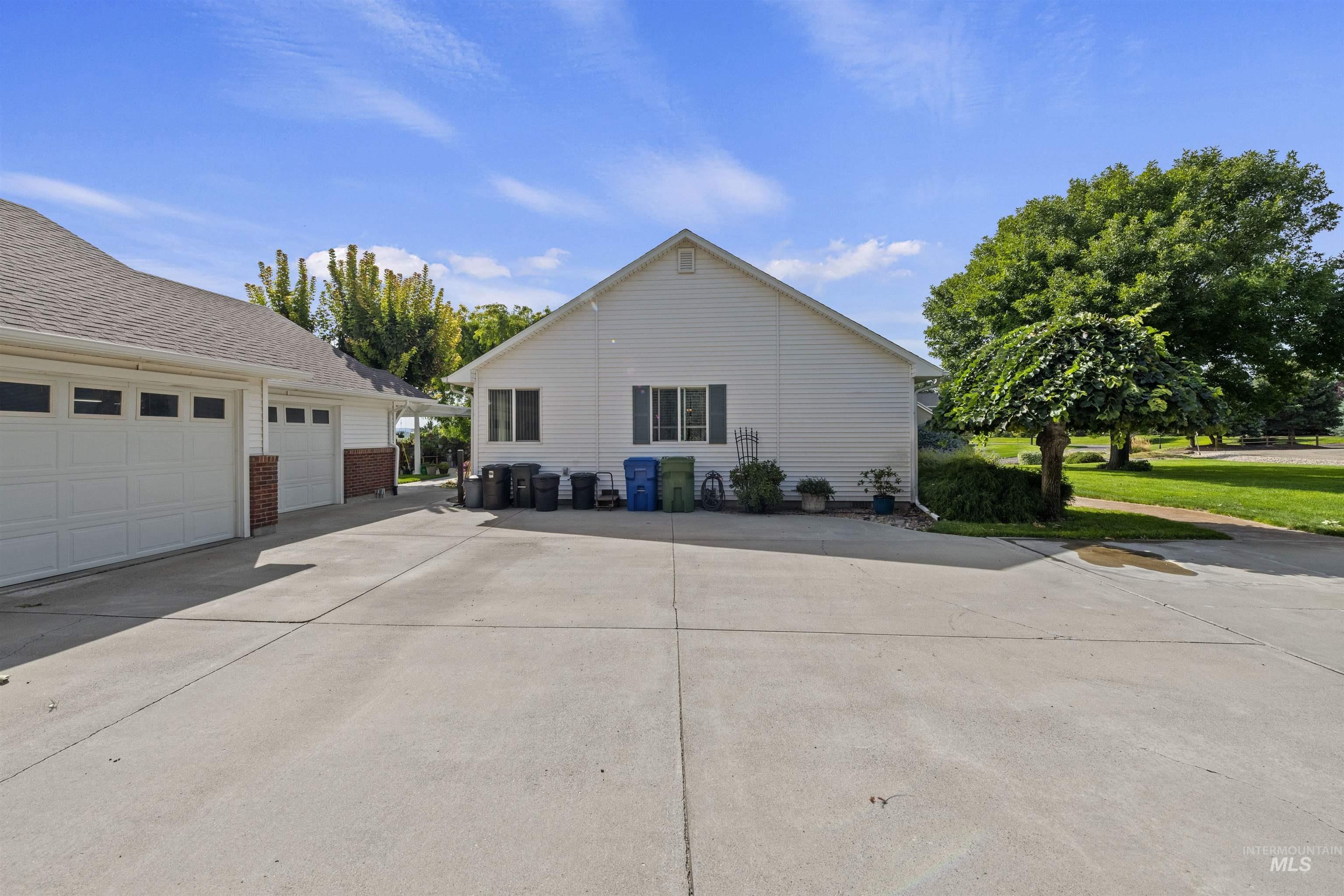 View of home's exterior with a garage and concrete driveway