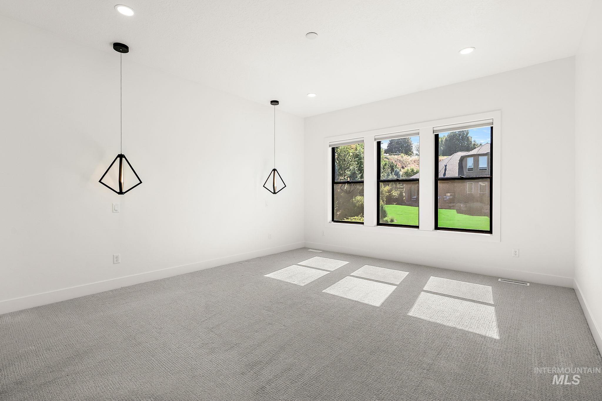 Empty room featuring carpet flooring and recessed lighting