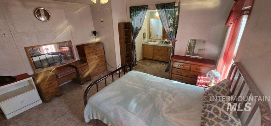 Bedroom featuring dark carpet