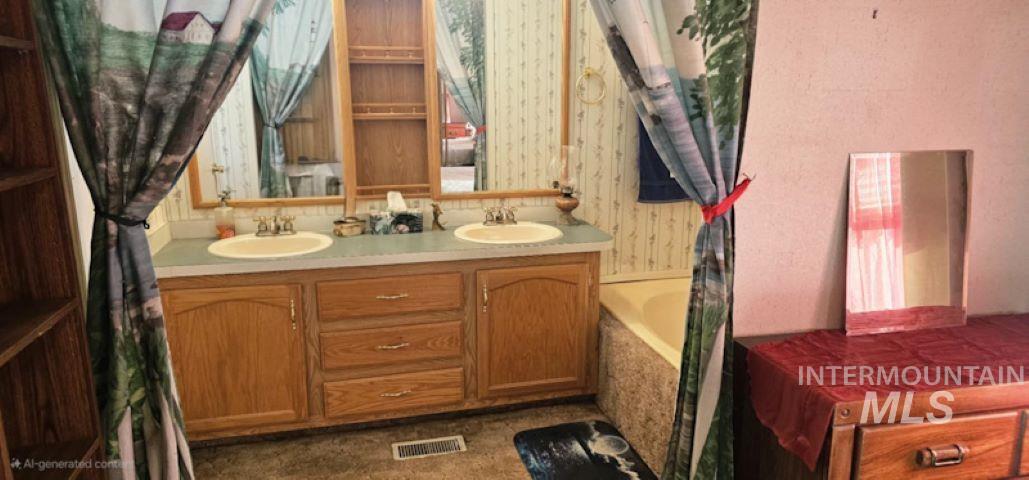 Full bath featuring double vanity and a tub to relax in