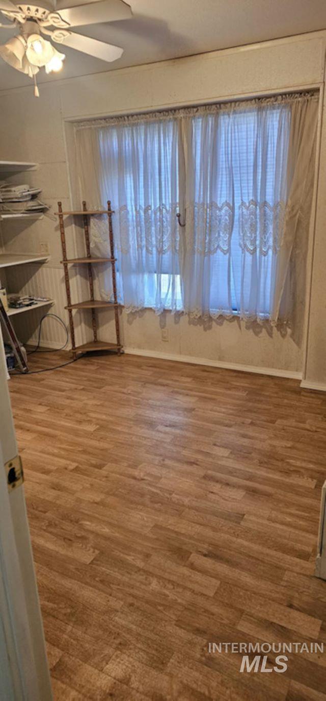 Spare room featuring light wood-style floors and a ceiling fan