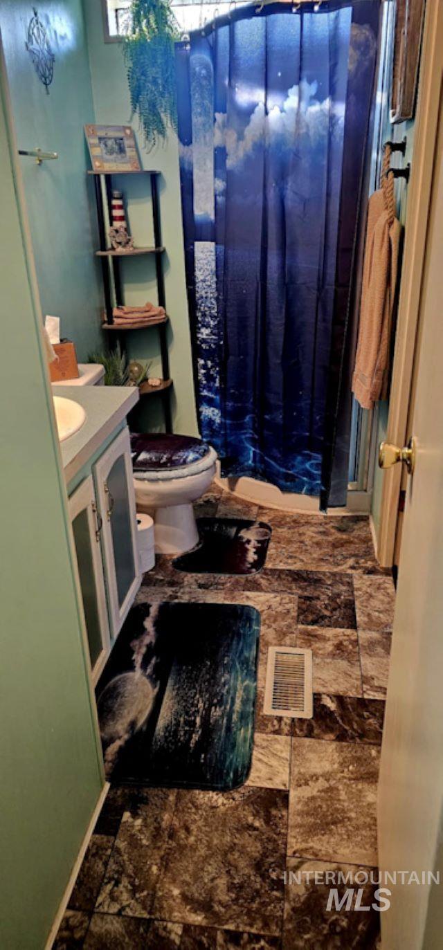 Bathroom with vanity and curtained shower