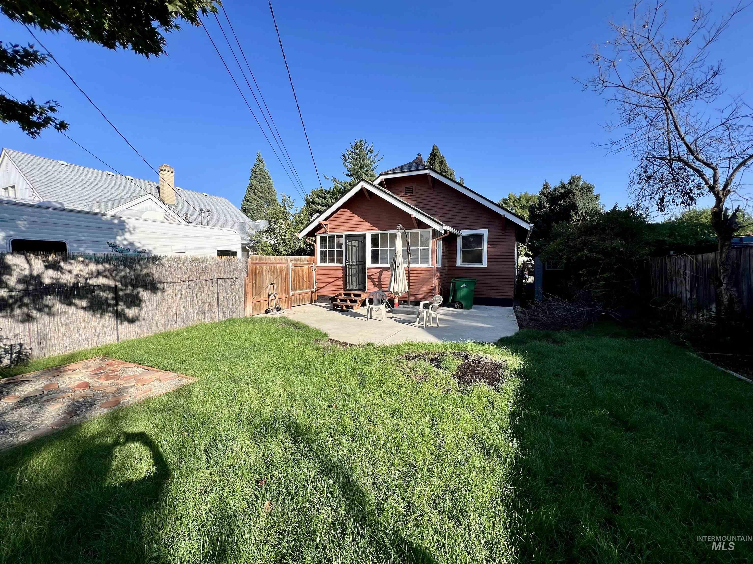 Back of property with a patio, a fenced backyard, and entry steps