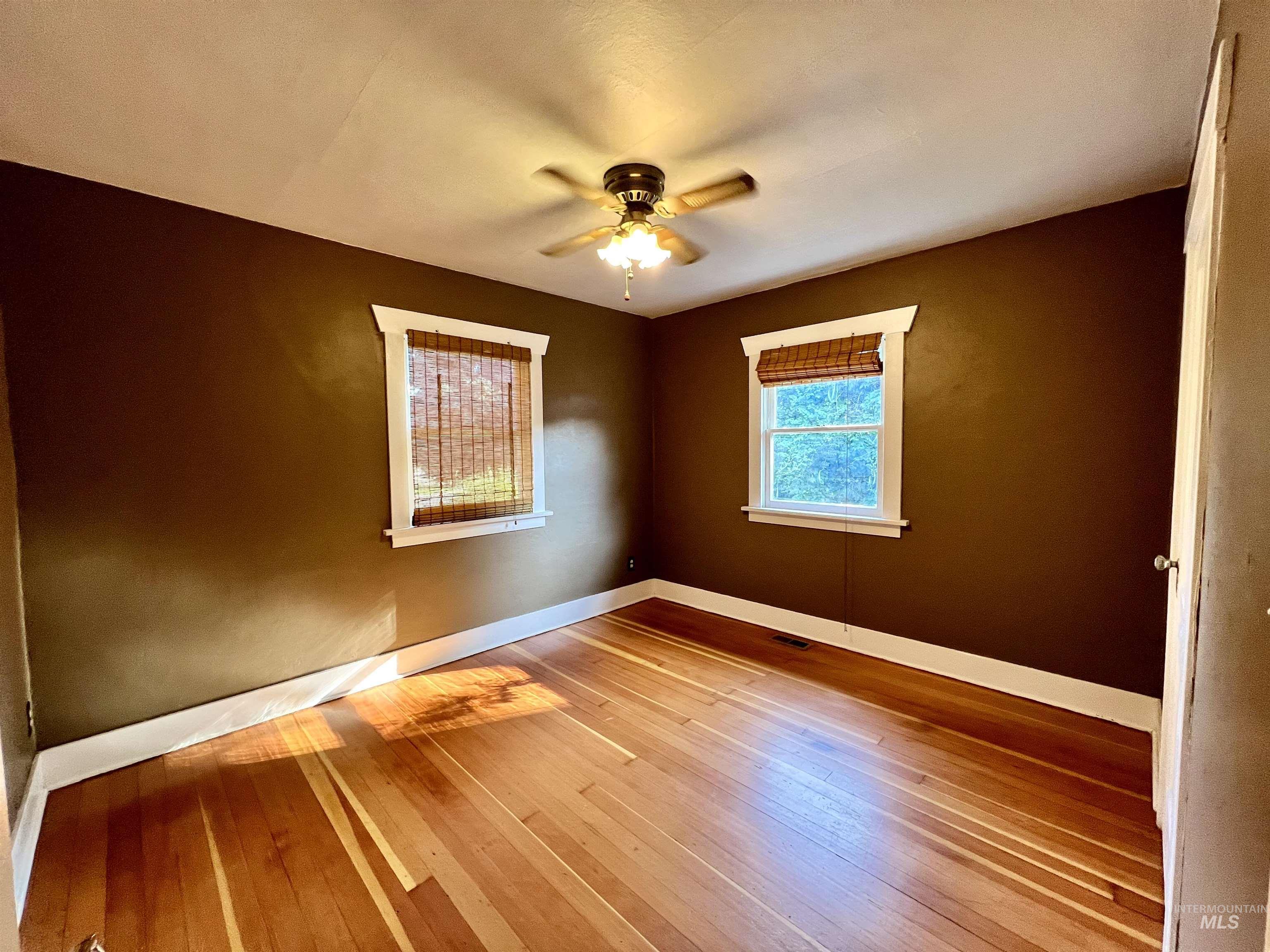 Spare room featuring light wood-style floors and a ceiling fan