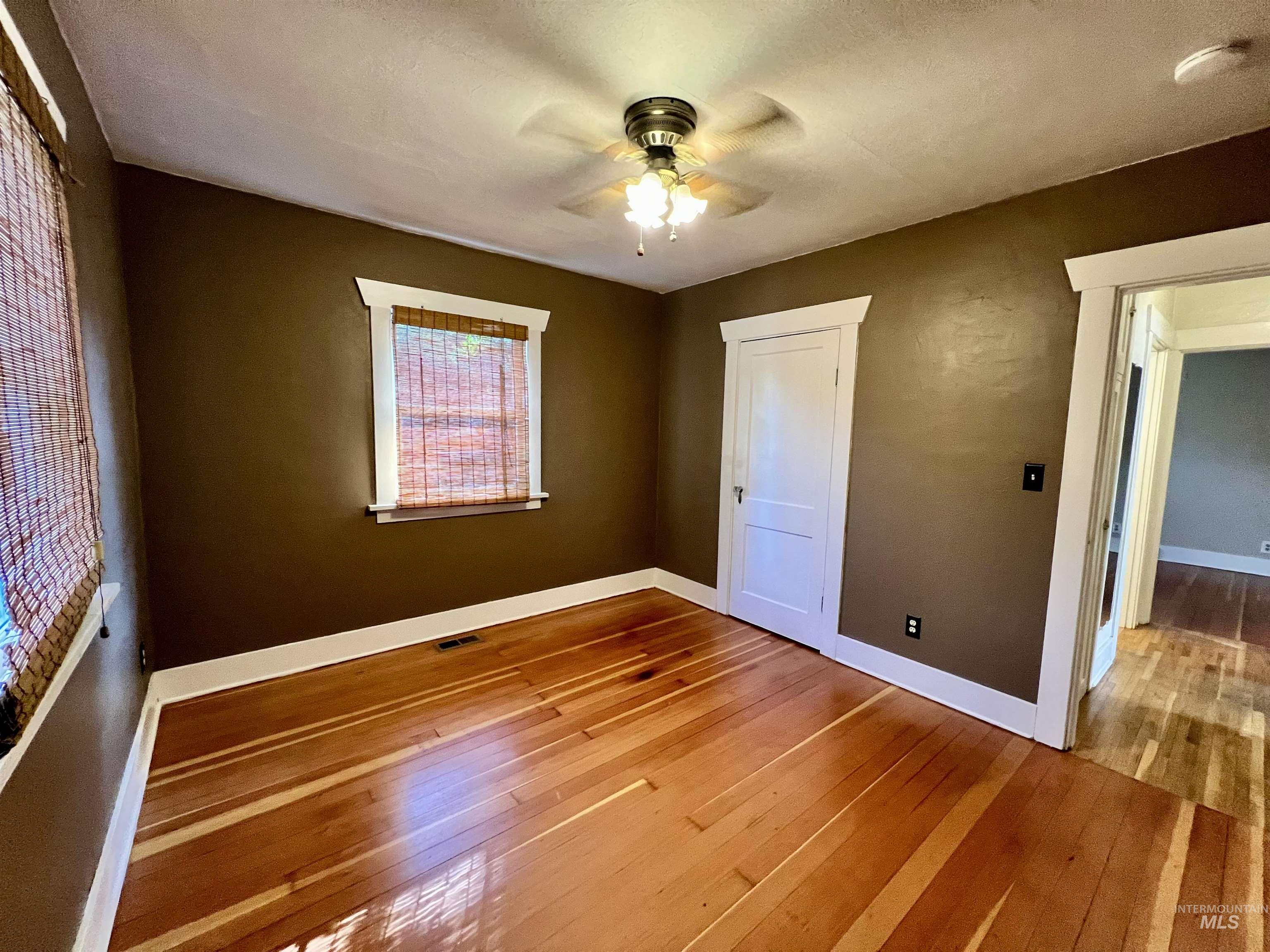 Unfurnished bedroom featuring light wood-style floors and a ceiling fan