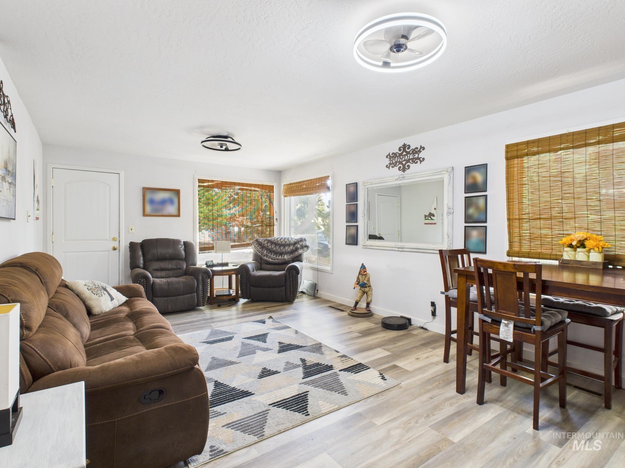 Living area featuring light wood-style floors and baseboards