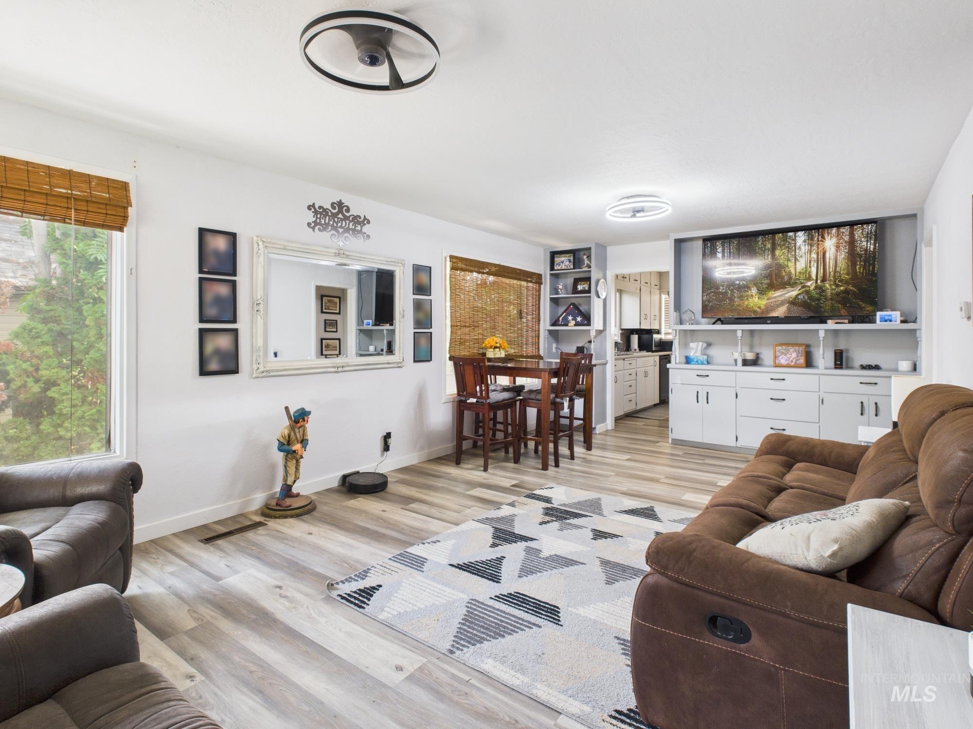 Living area with light wood-type flooring and baseboards