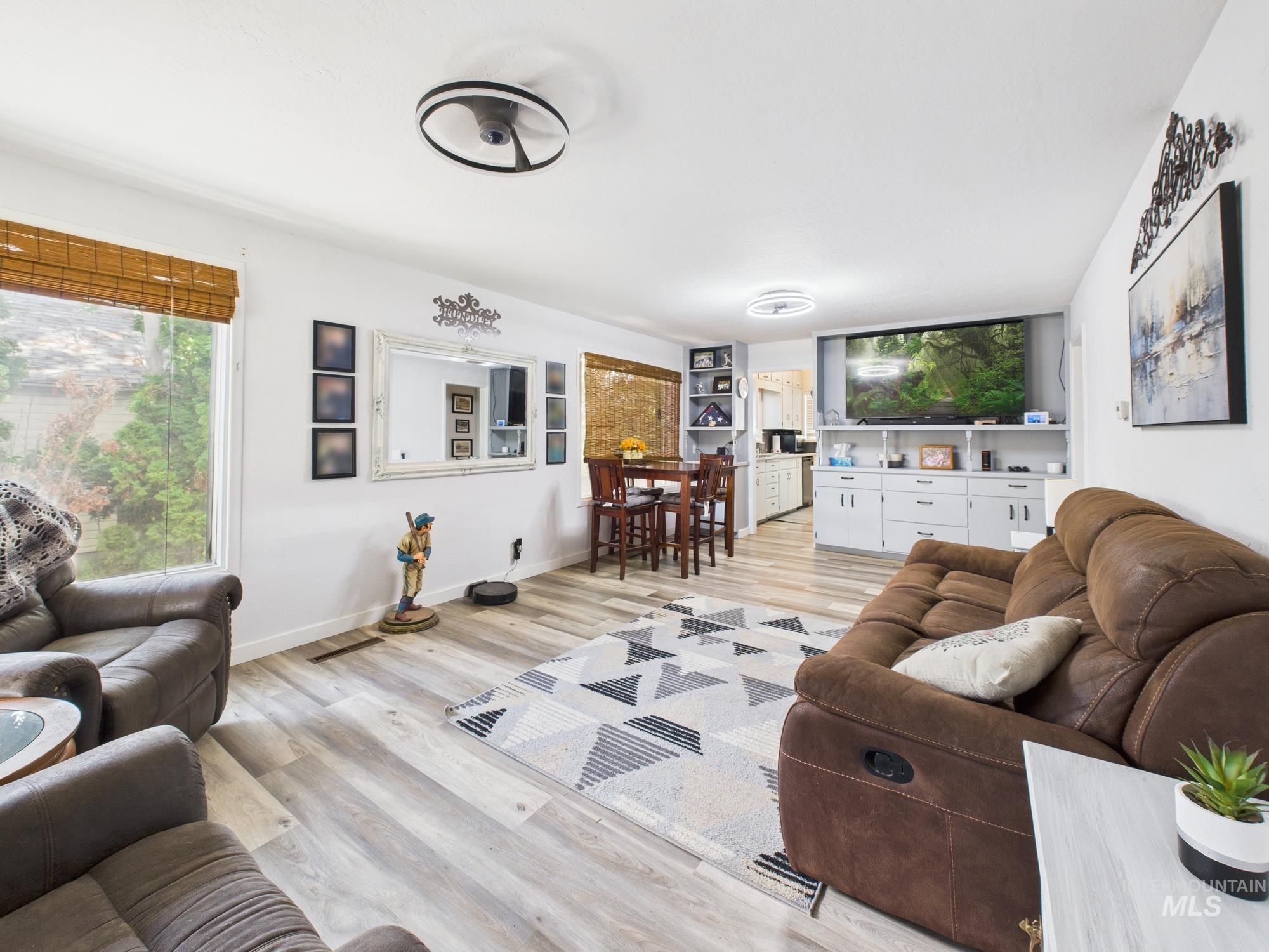 Living room with plenty of natural light and light wood-type flooring