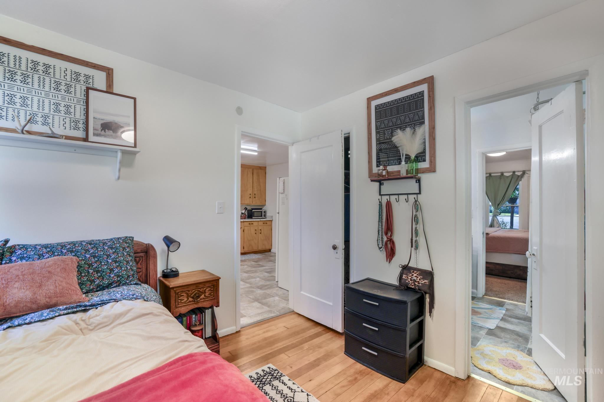 Bedroom featuring light wood-type flooring and baseboards