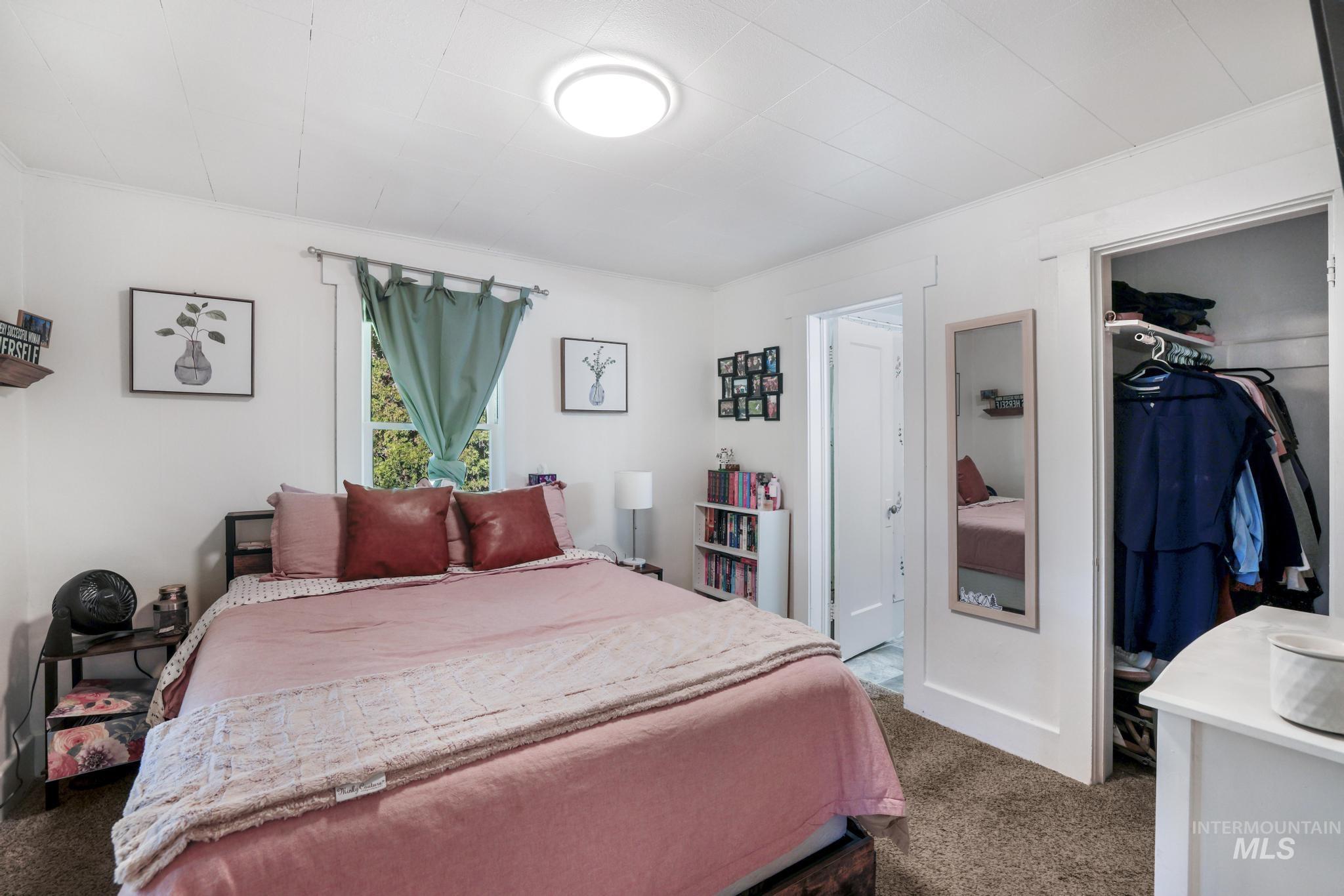 Bedroom featuring dark carpet