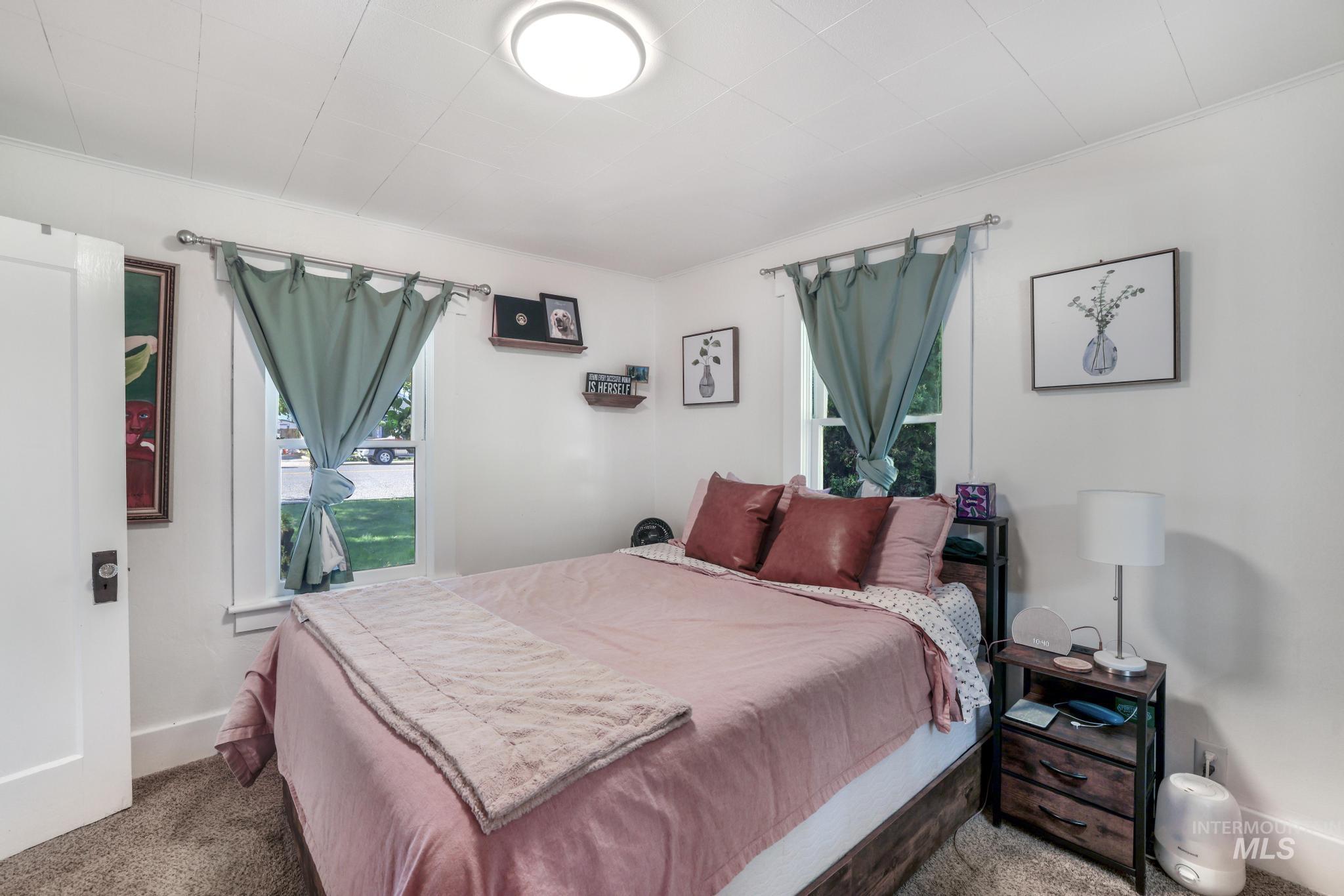 Bedroom featuring carpet floors and multiple windows