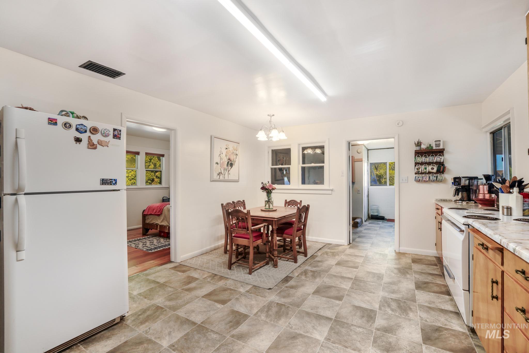 Dining space with a chandelier and baseboards