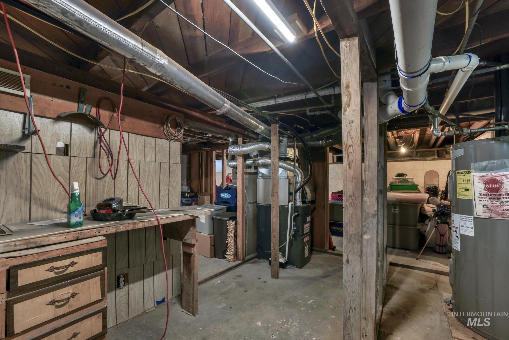 Unfinished below grade area with water heater and heating unit