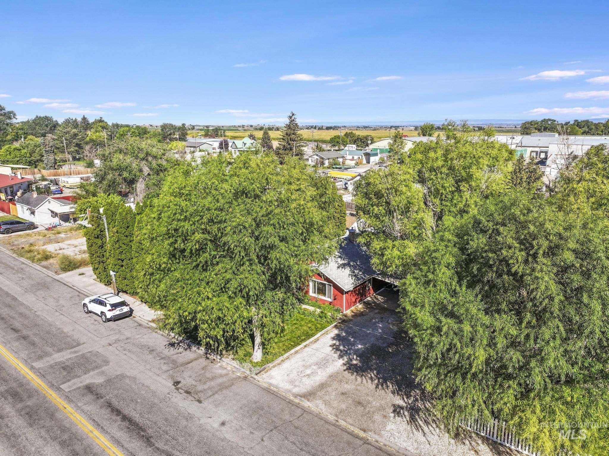 Aerial view of residential area featuring a tree filled landscape