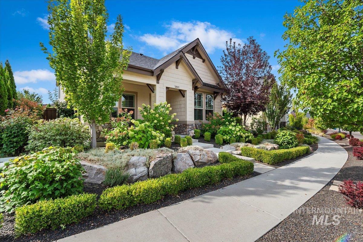 Craftsman-style house with stone siding and roof with shingles